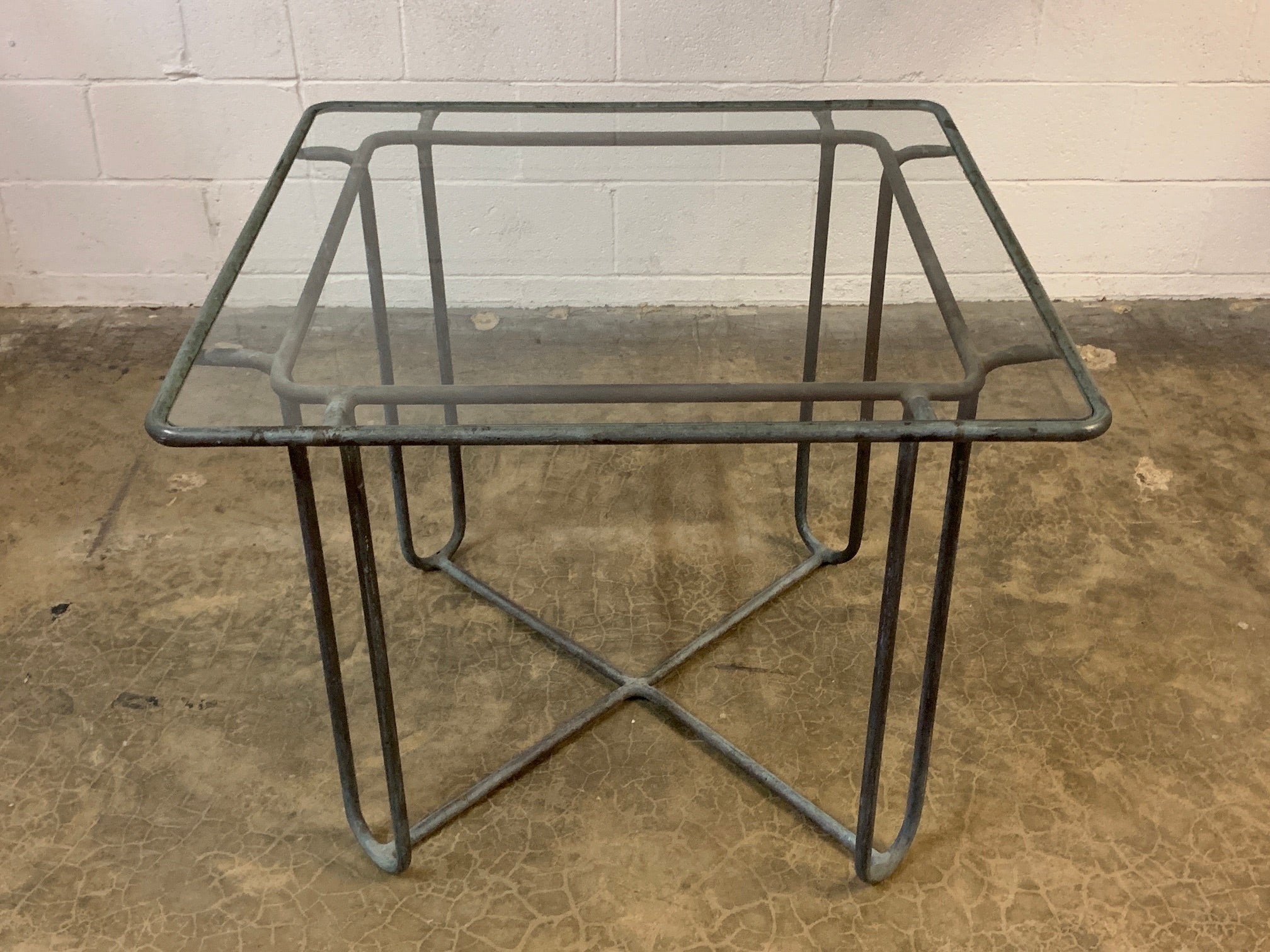 A beautifully patinated bronze outdoor table designed by Walter Lamb.