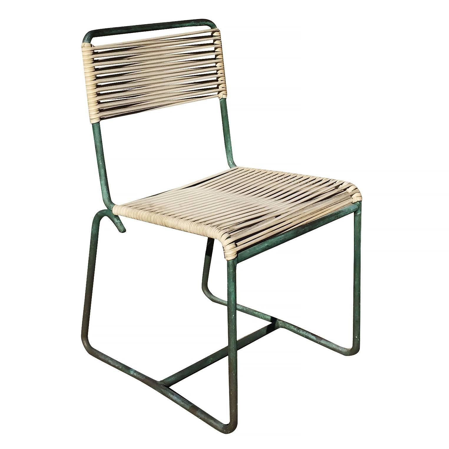 Set of four outdoor/patio tubular bronze frame chairs with cloth cording seat and back with a verdigris bronze finish.

This set includes 3 side chairs and armchair.

Designed by Walter Lamb and manufactured by Brown Jordan.