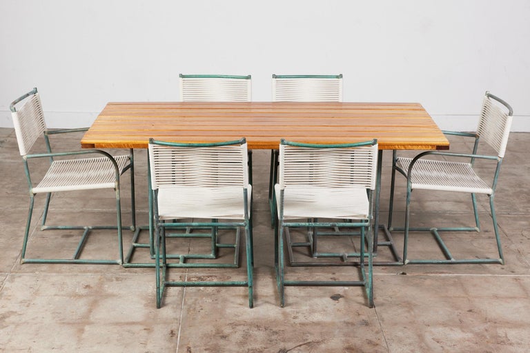 Dining set consisting of six chairs and rectangular wood top table by Walter Lamb dating from the late 40s or early 50s, either predating or from the early years of his work with Brown Jordan. The chairs have a frame in tubular bronze with the