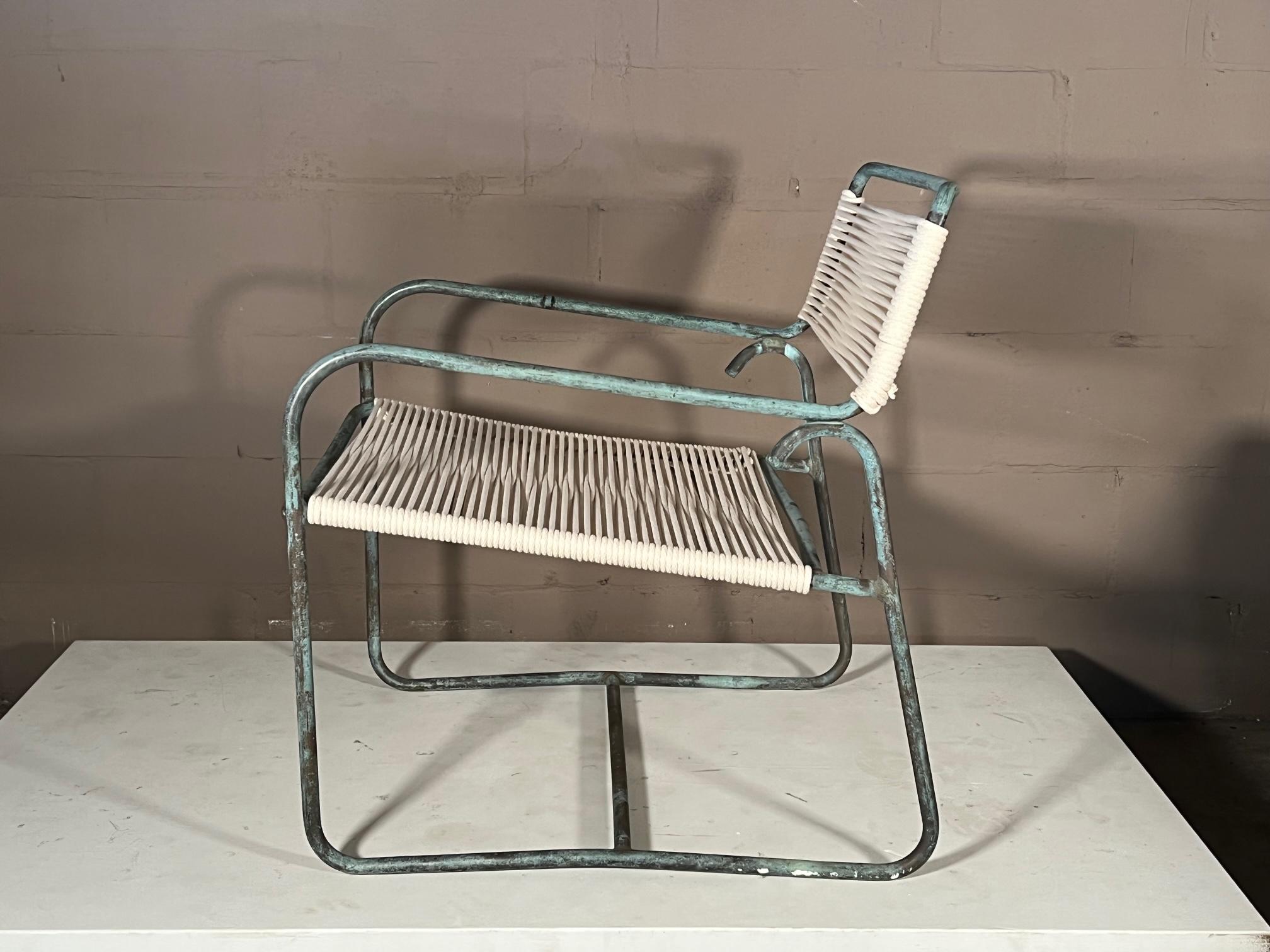 A classic Walter Lamb lounge chair by Brown Jordan with beautiful patina and cotton cord seat.