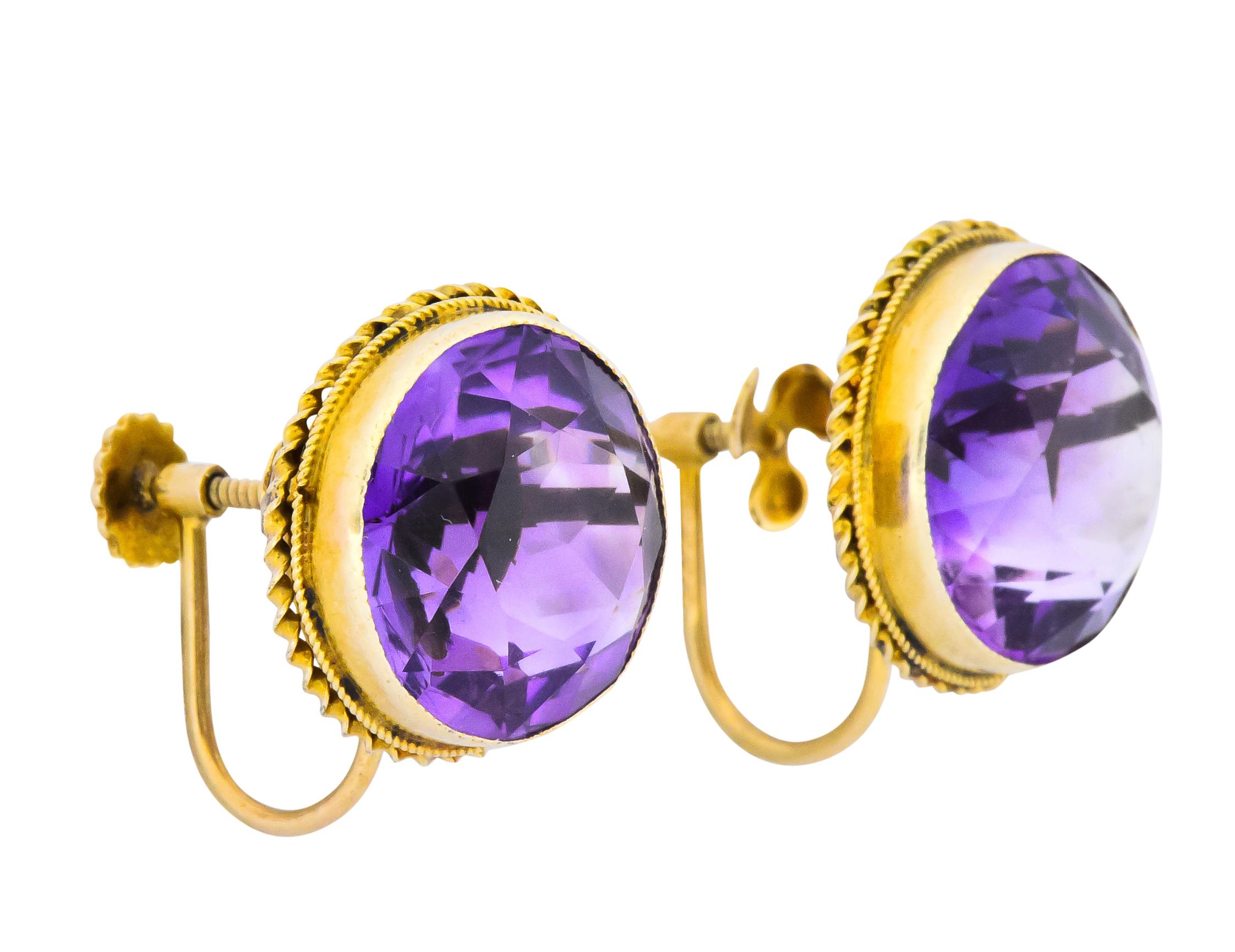 Each centering a modified round brilliant cut amethyst, weighing approximately 13.00 carats total

Both a rich royal purple and very well matched

Bezel set with twisted gold detail

Screw backs

Maker's mark for  Walter Lampl and stamped 14K

Circa
