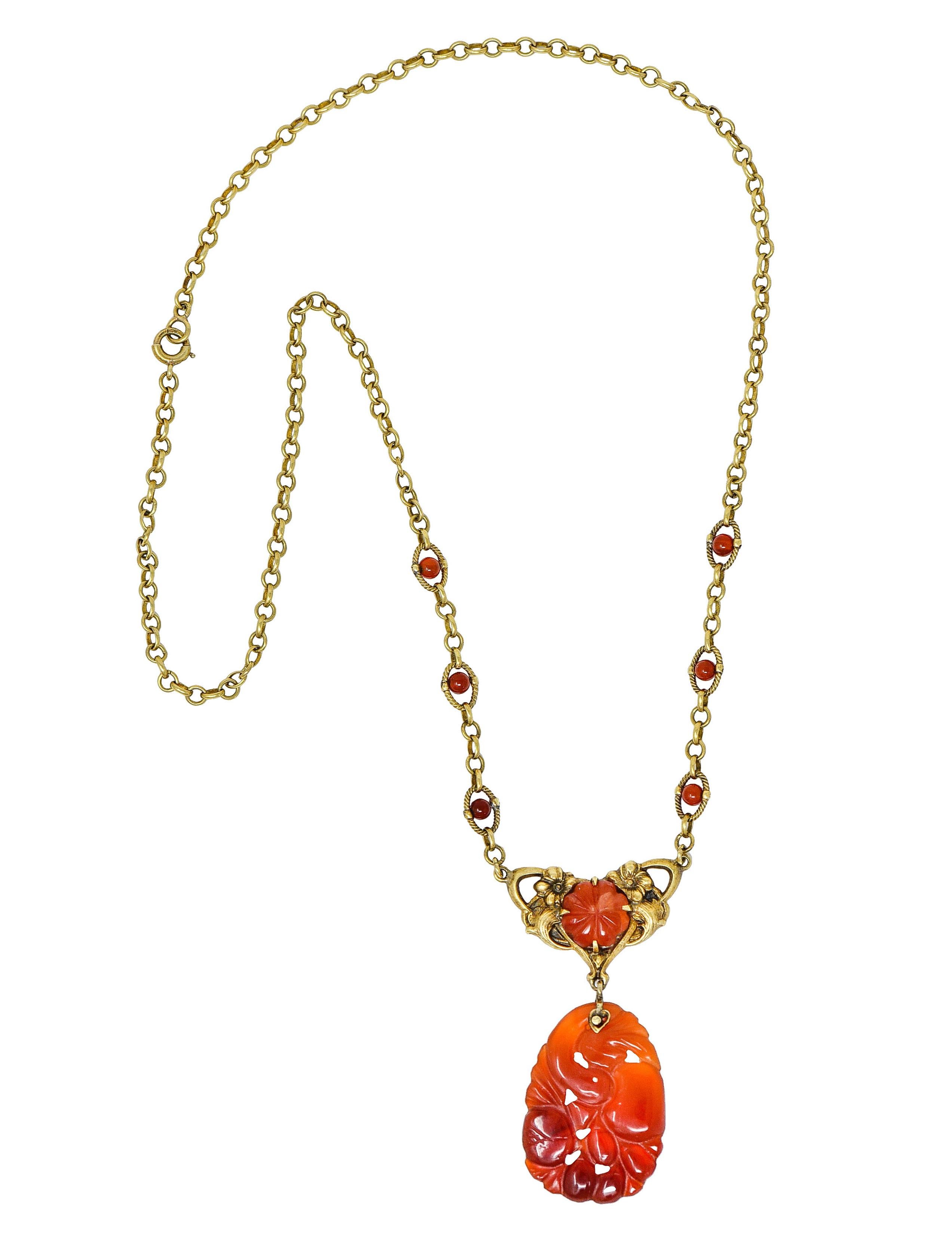 Antique cable chain necklace has six 2.5 mm carnelian bead stations with twisted rope surrounds

Featuring an ornate floral central station with a 9.0 mm pumpkin carved carnelian cabochon

Suspending an oval carnelian drop deeply carved with floral