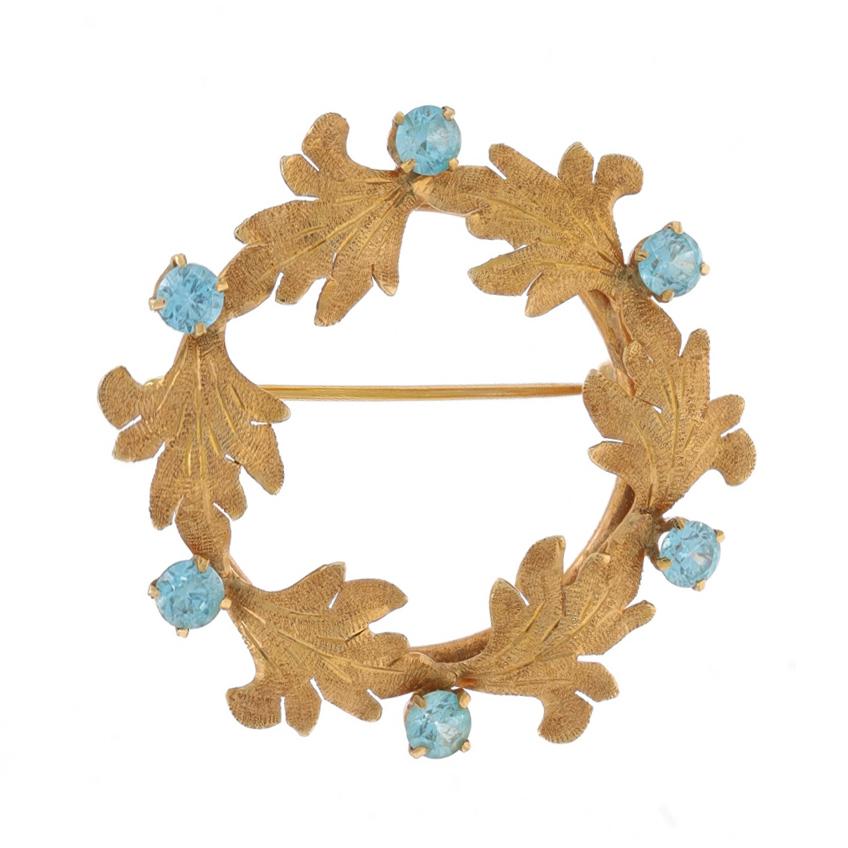 Brand: Walter Lampl
Era: Vintage

Metal Content: 14k Yellow Gold

Stone Information
Natural Blue Zircons
Carat(s): 1.92ctw
Cut: Round

Total Carats: 1.92ctw

Style: Brooch
Fastening Type: Hinged Pin and Whale Tail Bullet Clasp
Theme: Botanical