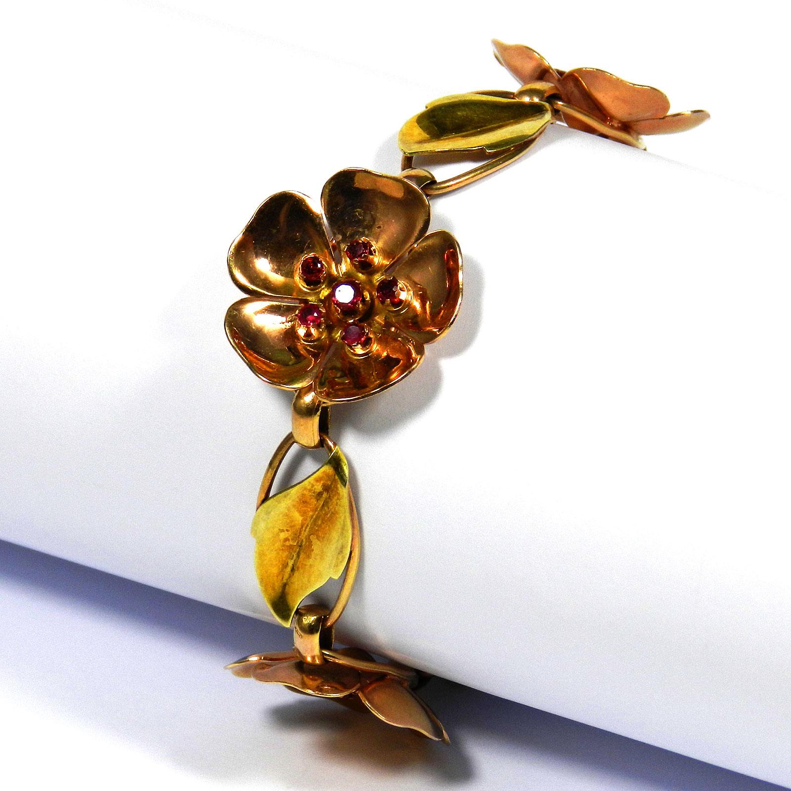 Walter Lampl Retro 14 K gold ruby flower bracelet, circa 1940

A rare two-tone Retro flower bracelet from New York's jewelry designer Walter Lampl. 
Its design comprises three rose gold blossoms set with rubies, which alternate with oval links,