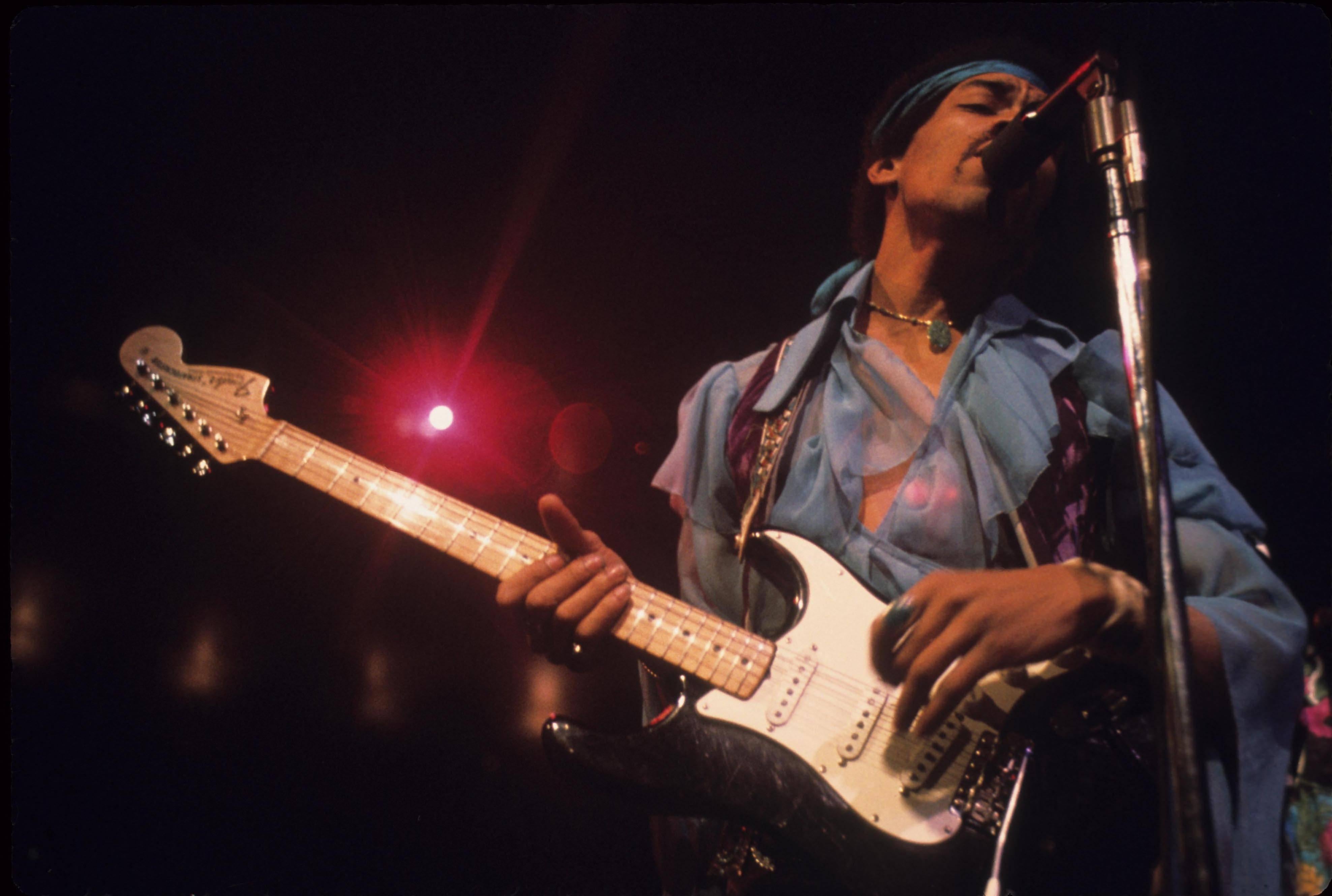 Walter Iooss Color Photograph - Jimi Hendrix on Stage in Blue Globe Photos Fine Art Print