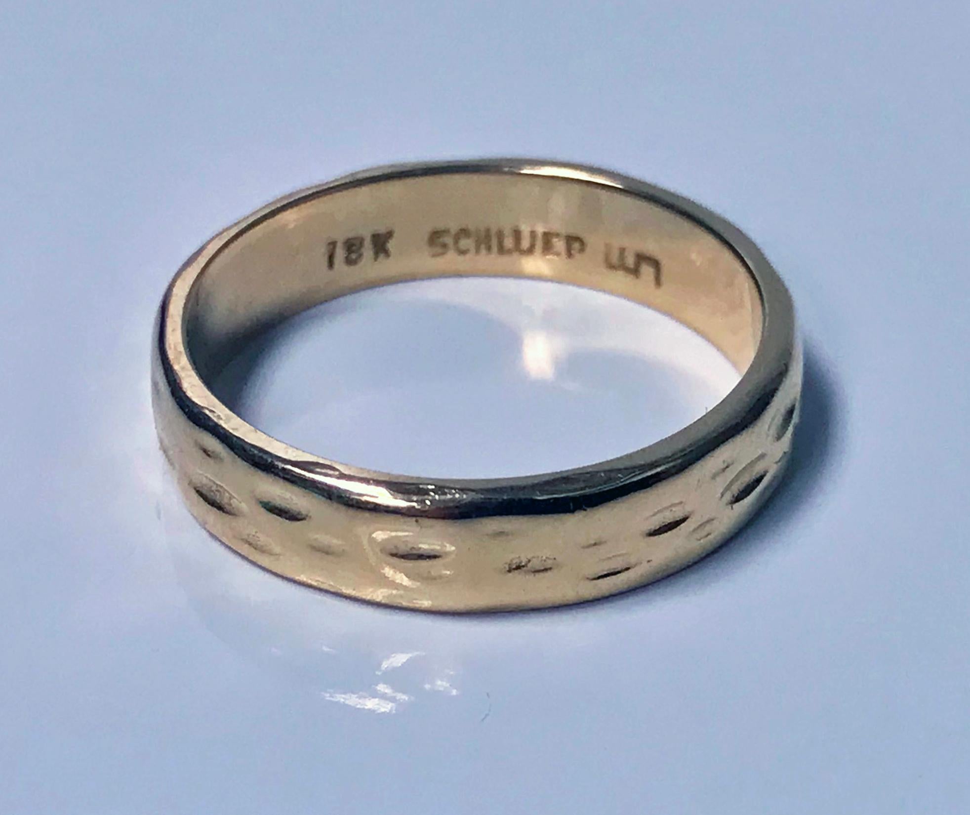 Walter Schluep 18K Band. C.1960. The handmade band of a hammered beaten design. Full Schluep and 18K marks to interior. Width of band: 4.00 mm. Ring Size: 6.25. Item Weight: 4.00 grams.
