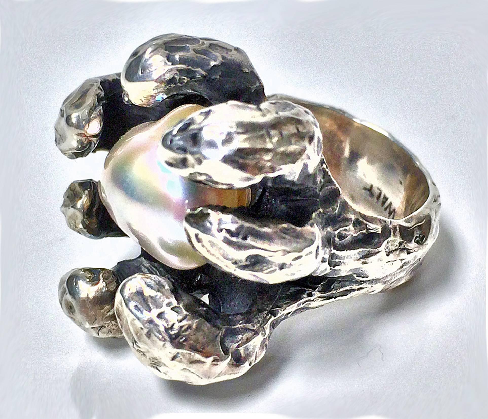 Modernist Walter Schluep Figurative Sterling Silver and Pearl Ring, Canadian C.1970.  Handmade hammered ring eagle claw set with silver white baroque pearl. Top measures approximately 15 x 10 mm. Ring Size 7. Total Item Weight: 22.47grams. 