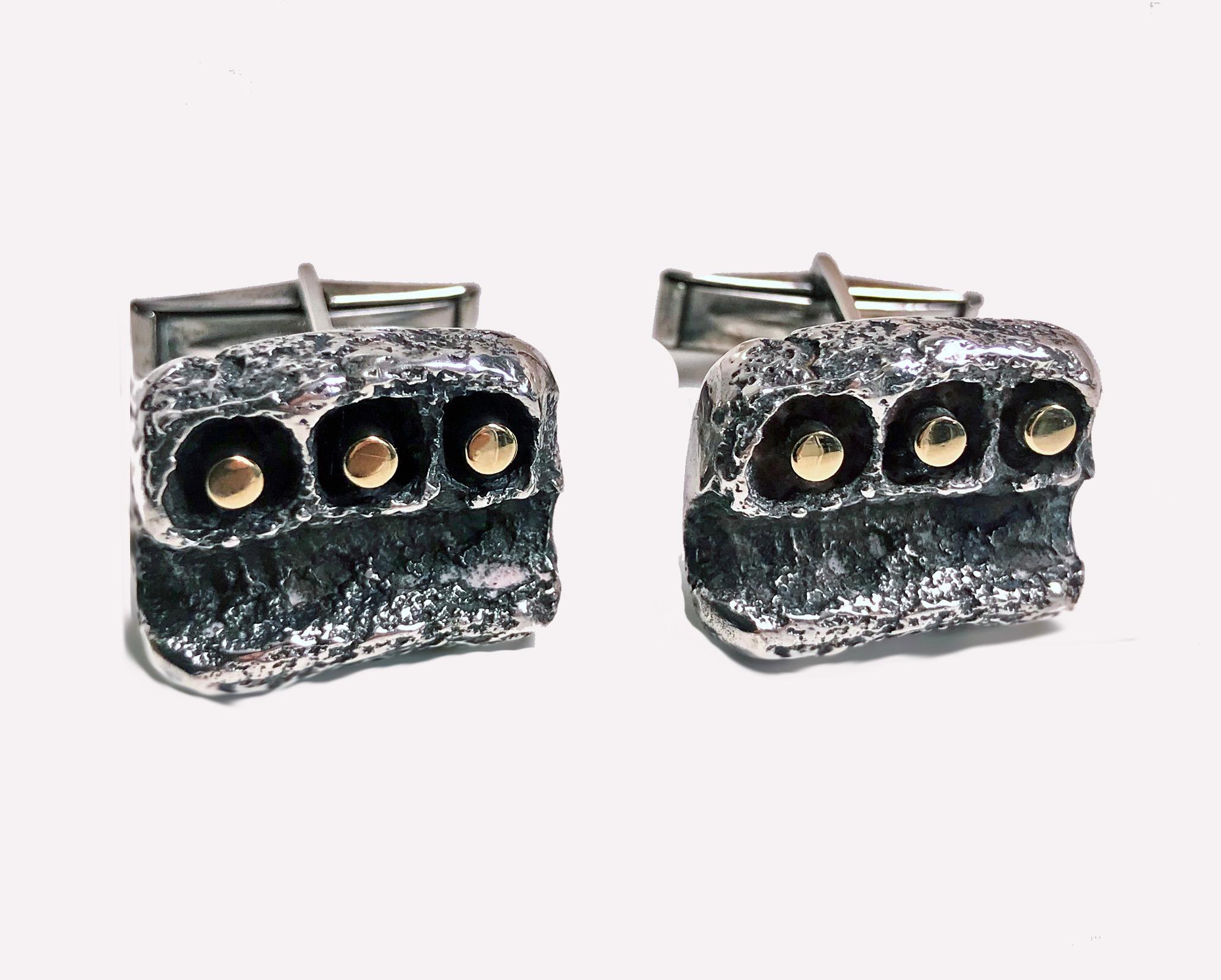 Pair Walter Schluep Gold and Sterling Cufflinks C.1960. Each of a textured brutalist design with three slightly protruding 18K cylinder rods, the surround of free form textured nugget sterling. Walter Schluep mark to reverse. Measure: 20.06 x 16.30