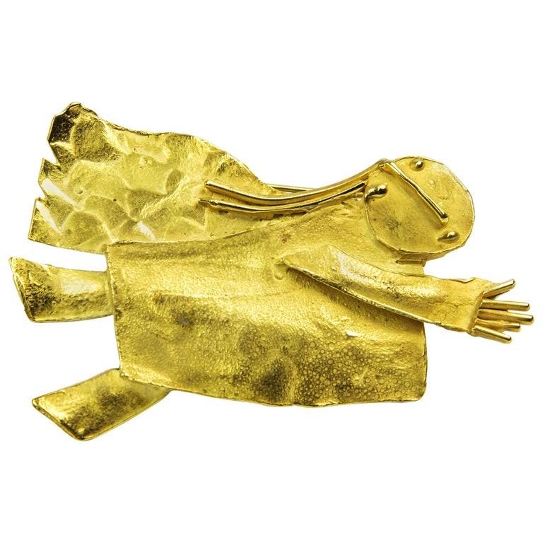 One-of-a-Kind signed Walter Schluep Figurative Guardian Angel Pin in solid
18k Gold; inspired by Marc Chagall’s interpretation of angels; approx. size: 2.5” x 1.5” Marked: 18K SCHLUEP plus his trademark signature. All handmade and hand hammered;