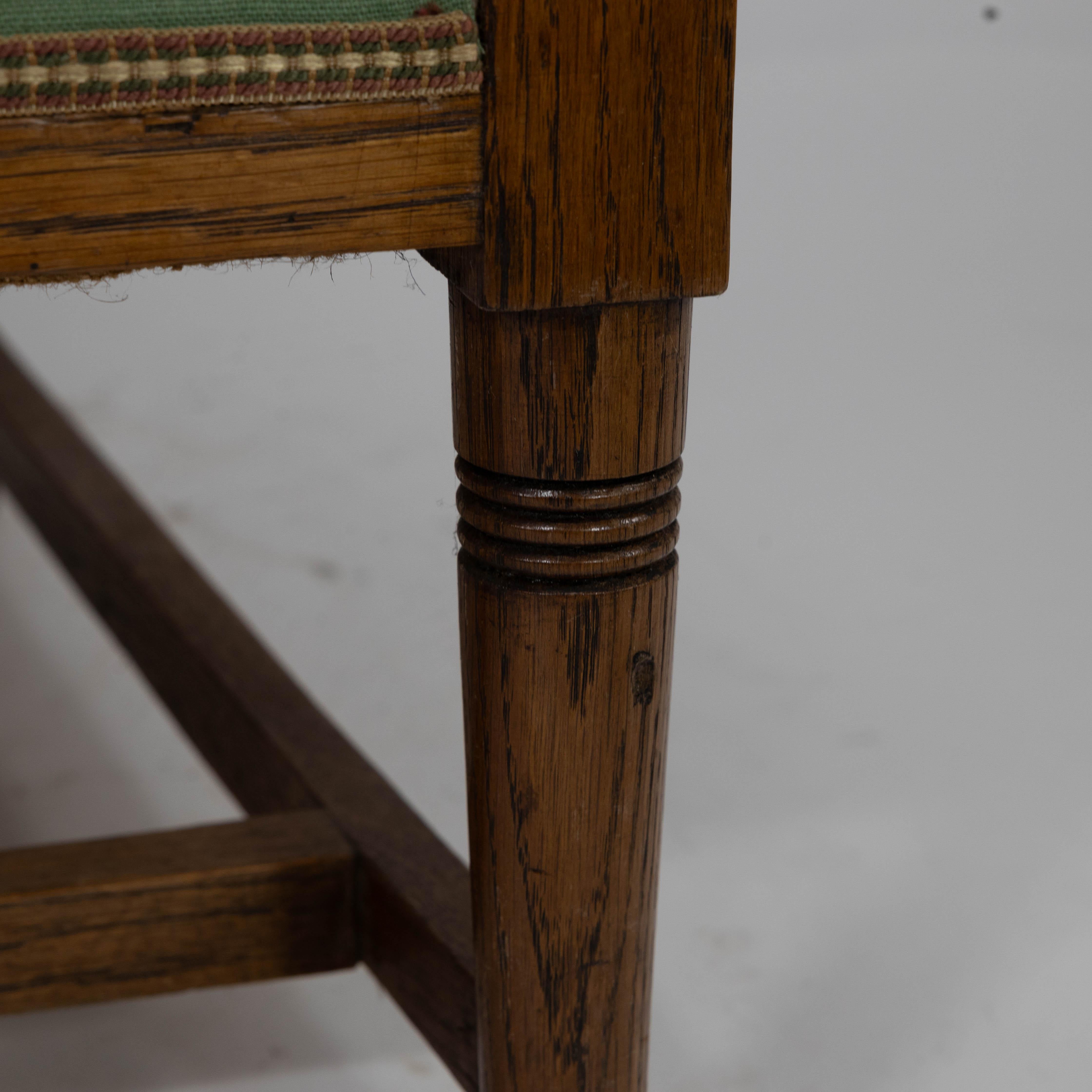 Walter Skull High Wycombe. An Arts and Crafts oak wing back upholstered armchair For Sale 2