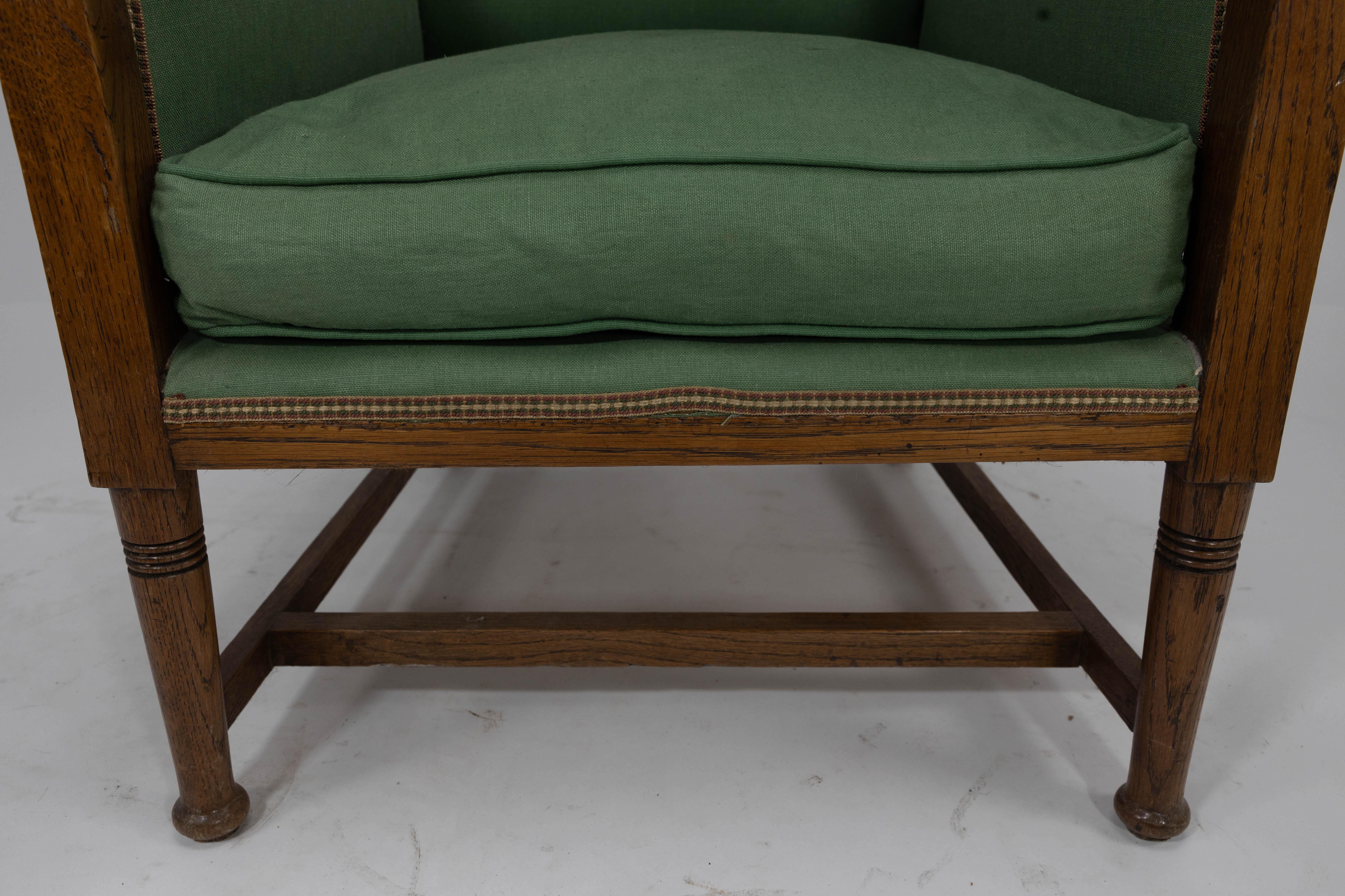 Walter Skull High Wycombe. An Arts and Crafts oak wing back upholstered armchair For Sale 3