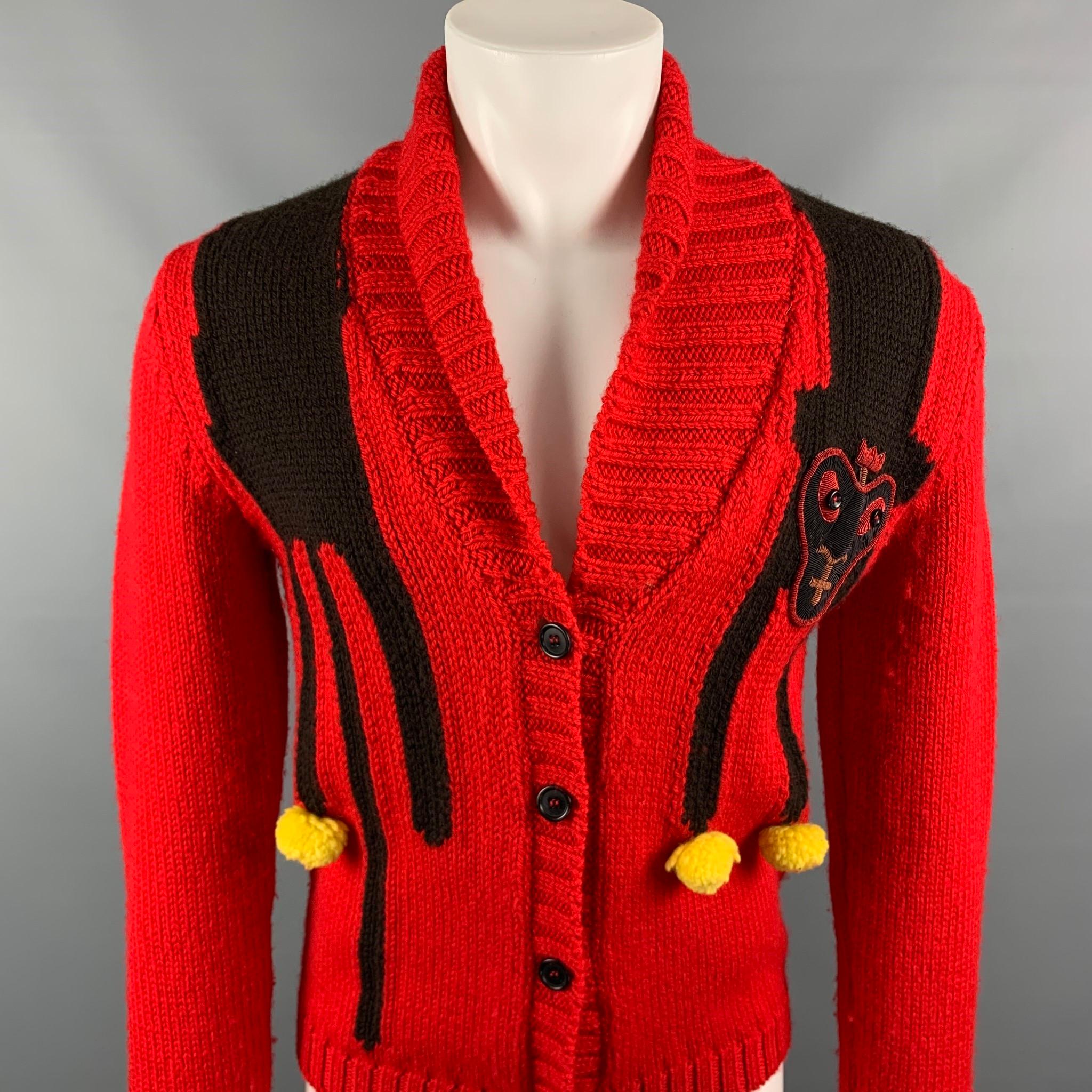 WALTER VAN BEIRENDONCK cardigan comes in a red & yellow knitted wool with a face patch design featuring a shawl collar and a buttoned closure. Made in Belgium.

Very Good Pre-Owned Condition.
Marked: S

Measurements:

Shoulder: 17.5  in.
Chest: 38