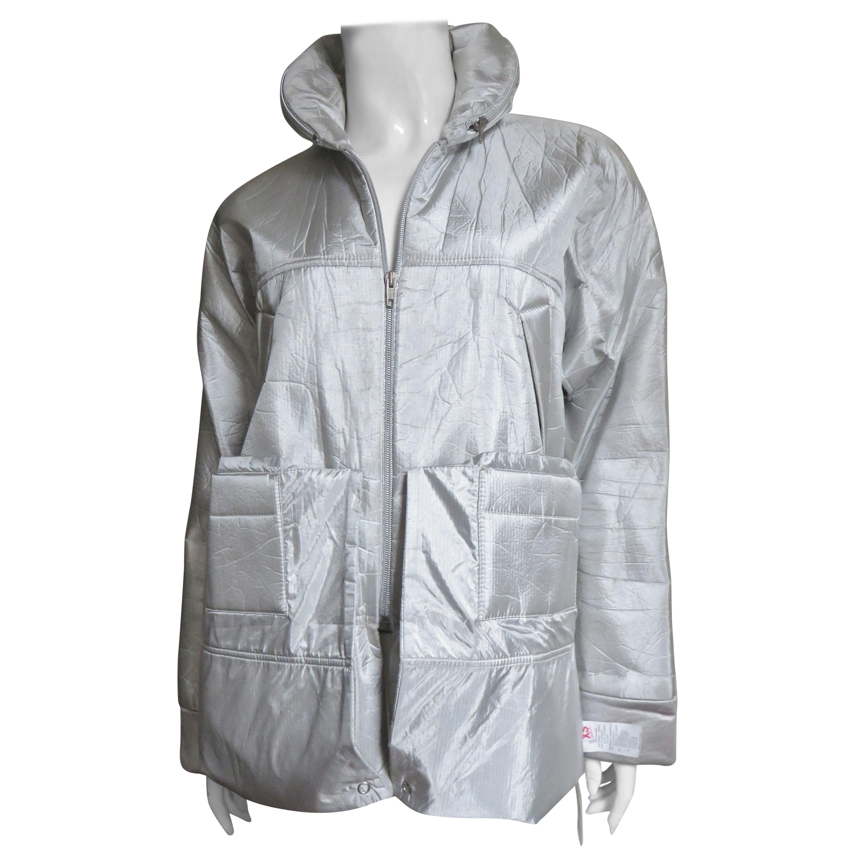 A fabulous convertible silver jacket/coat and hood from Walter Van Beirendonck for Wild and Lethal Trash.  The knee length dolman sleeve jacket has a zipper front and snaps allowing the hem to be folded up to upper thigh length.  It has a rounded