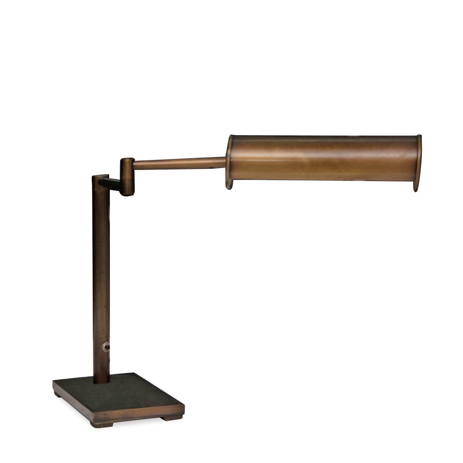 Walter Von Nessen by Nessen Studio / library table lamp in antiqued brass finish.

USA, circa 1970.

Features a swing arm and pivoting, perforated, cylindrical shade.  Complemented by natural aged patina and minor age-commensurate