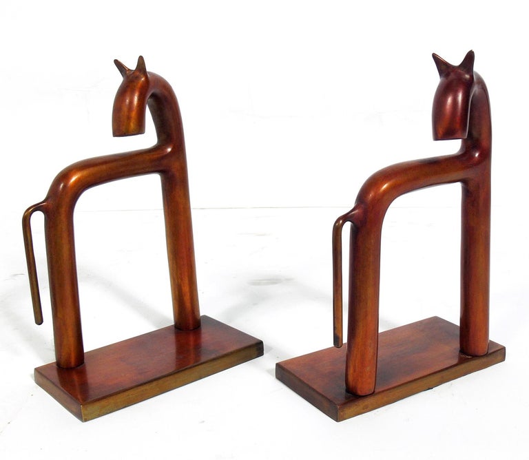 Pair of sculptural Art Deco bookends, designed by Walter Von Nessen for Chase, unsigned, American, circa 1930s. They are believed to be constructed of brass, but have taken on a warm bronze color patina.