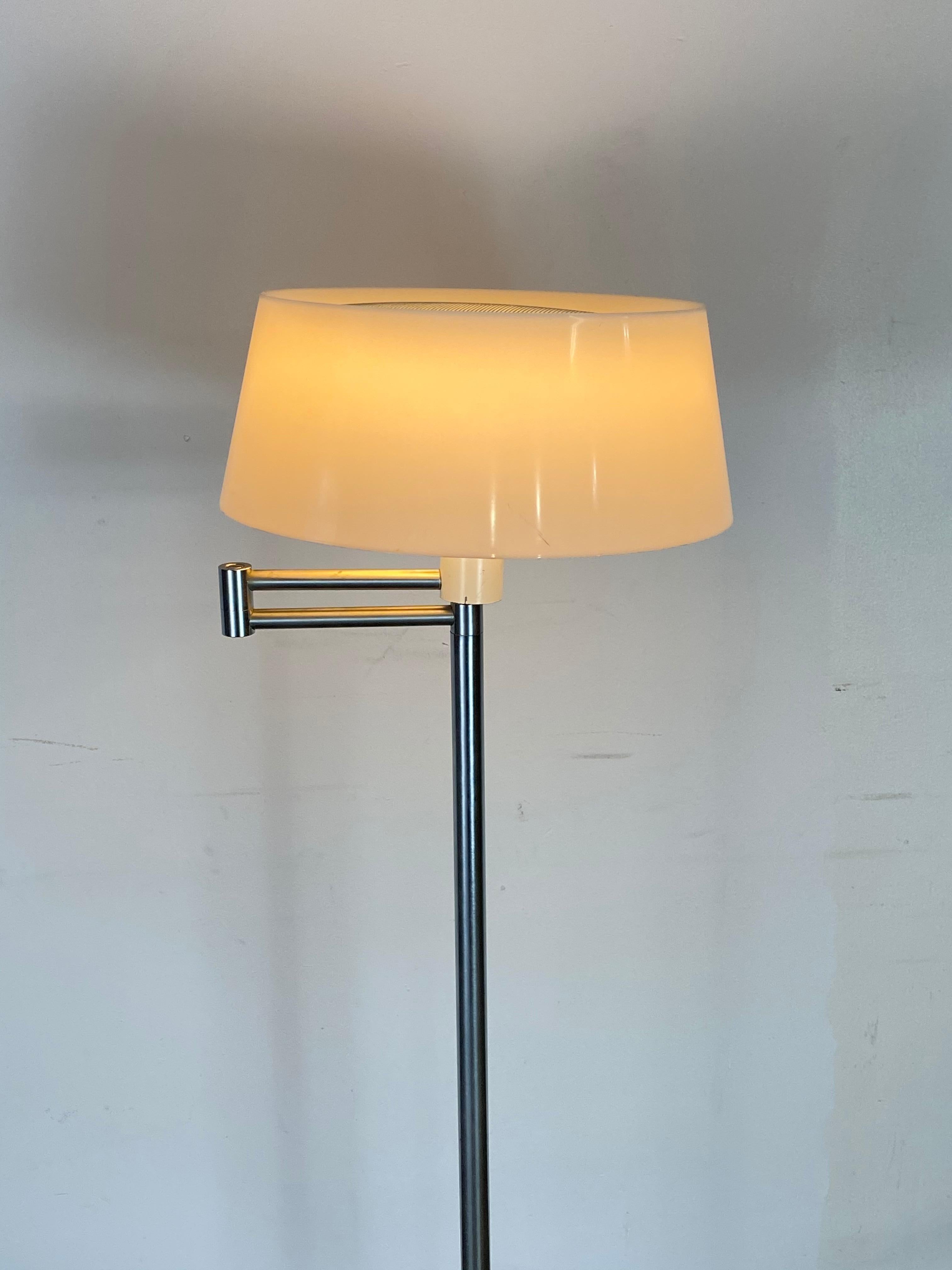 Heavy floor lamp designed by Walter Von Nessen. Original plastic molded shade with perforated screen insert at top. The top screen provides a gorgeous effect when illuminated. Tested and working.