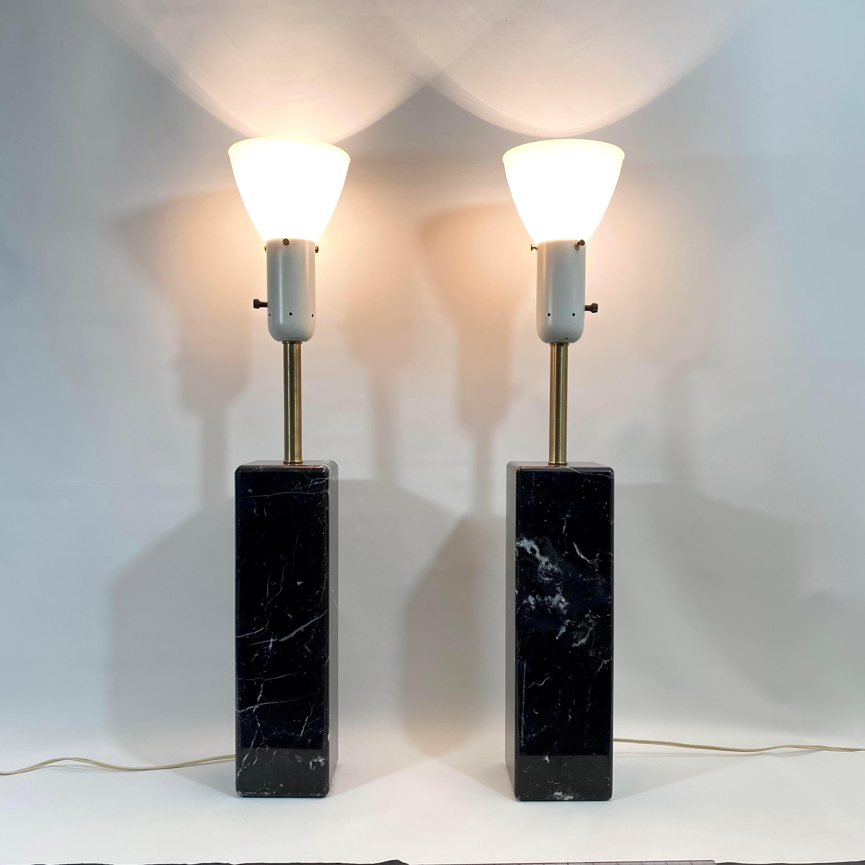Vintage circa 1960s Water Von Nessen lamp pair. Lamps have glass diffusers to hold shades. Black marble with white veining throughout and brass neck. Lamps each weight approximately 33+ lbs. One lamp is marked with makers mark sticker.
Marble base