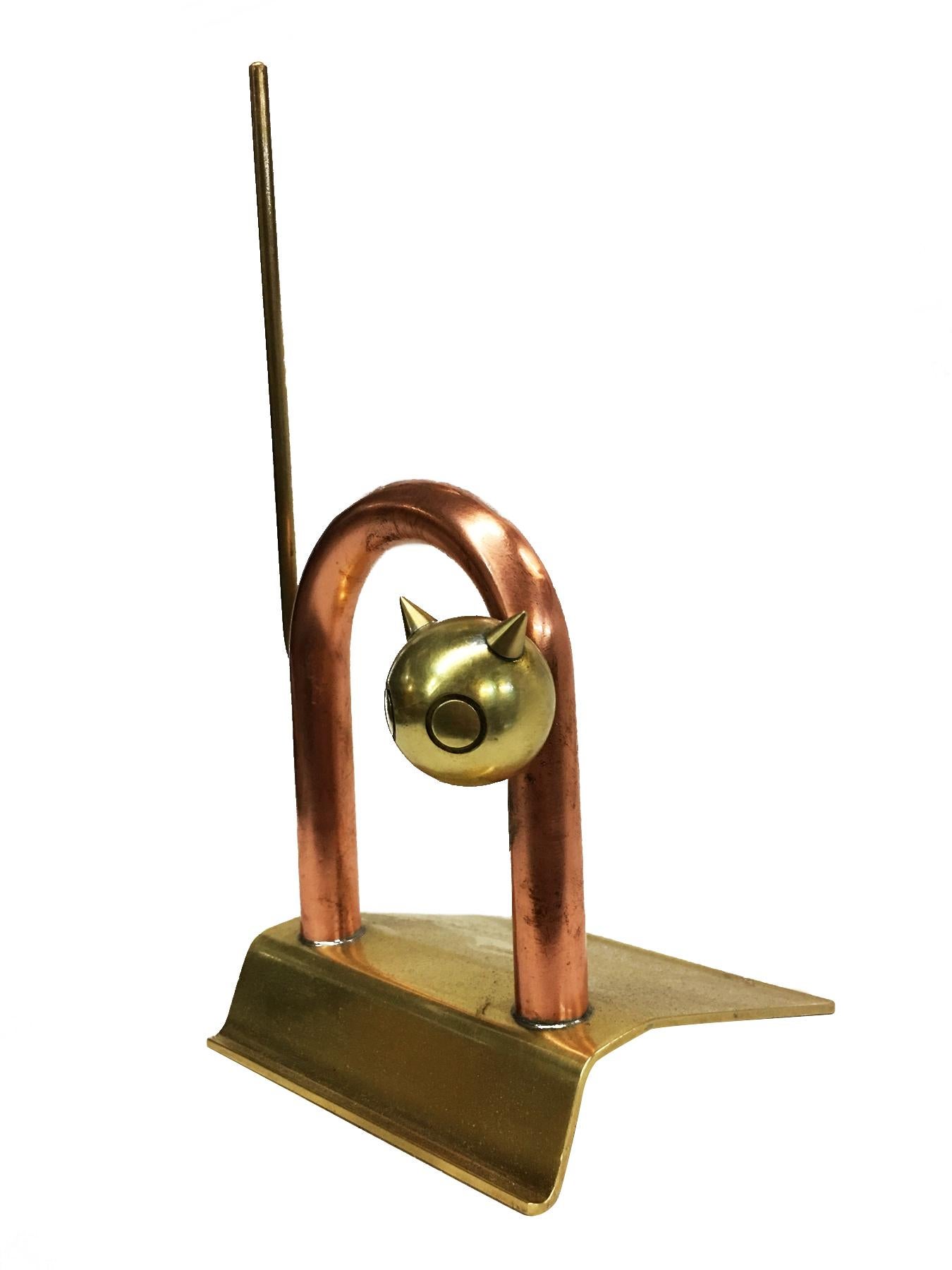 Art Deco Era brass and copper cat statue designed by Walter Von Nessen for the Chase Brass Company. It has been used as a doorstop or a bookend, too.