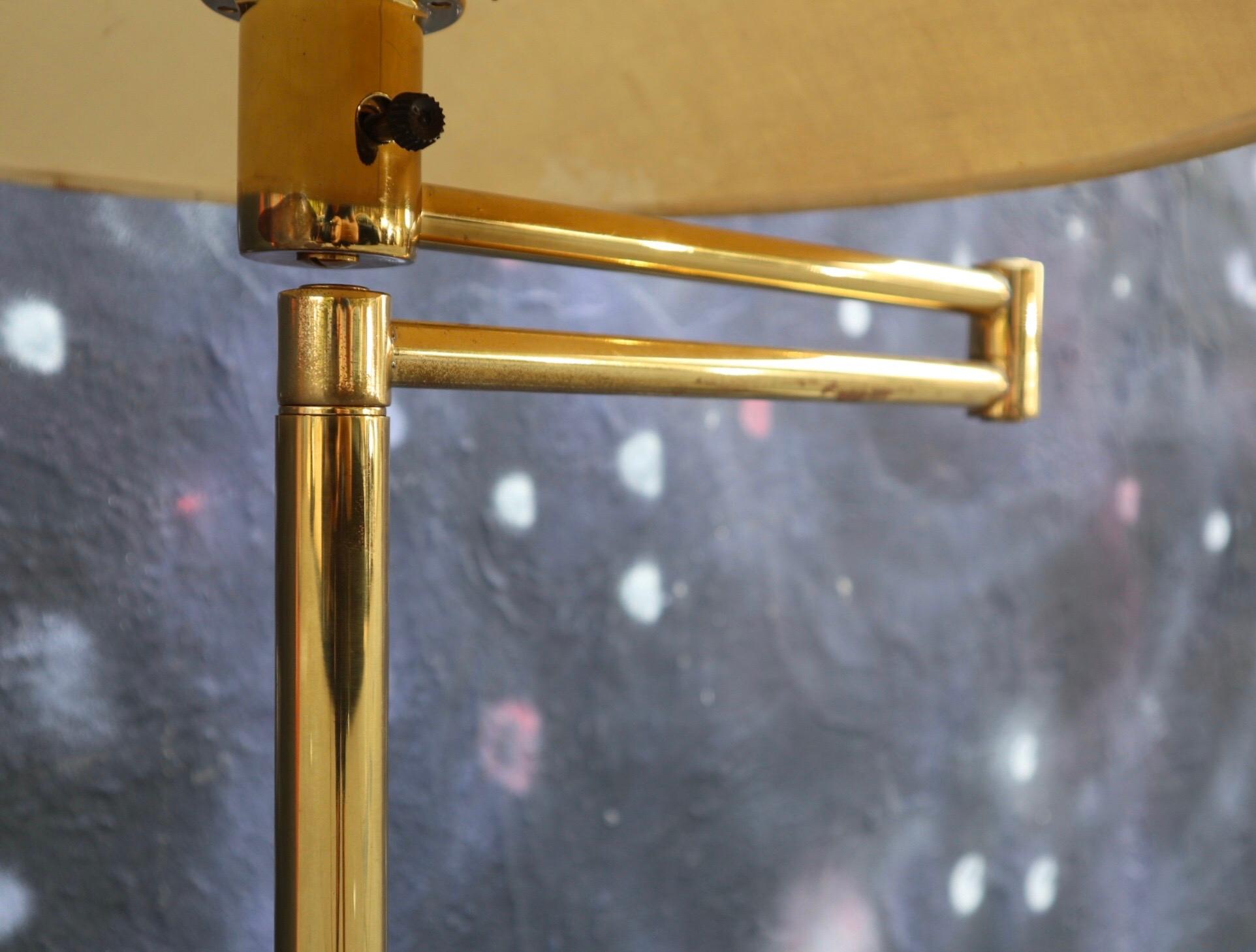 Walter Van Nessen brass floor lamp. Swing arm extends with original shade. Works great. Normal wear to lamp base and shade. Lamp adjusts in height from 49