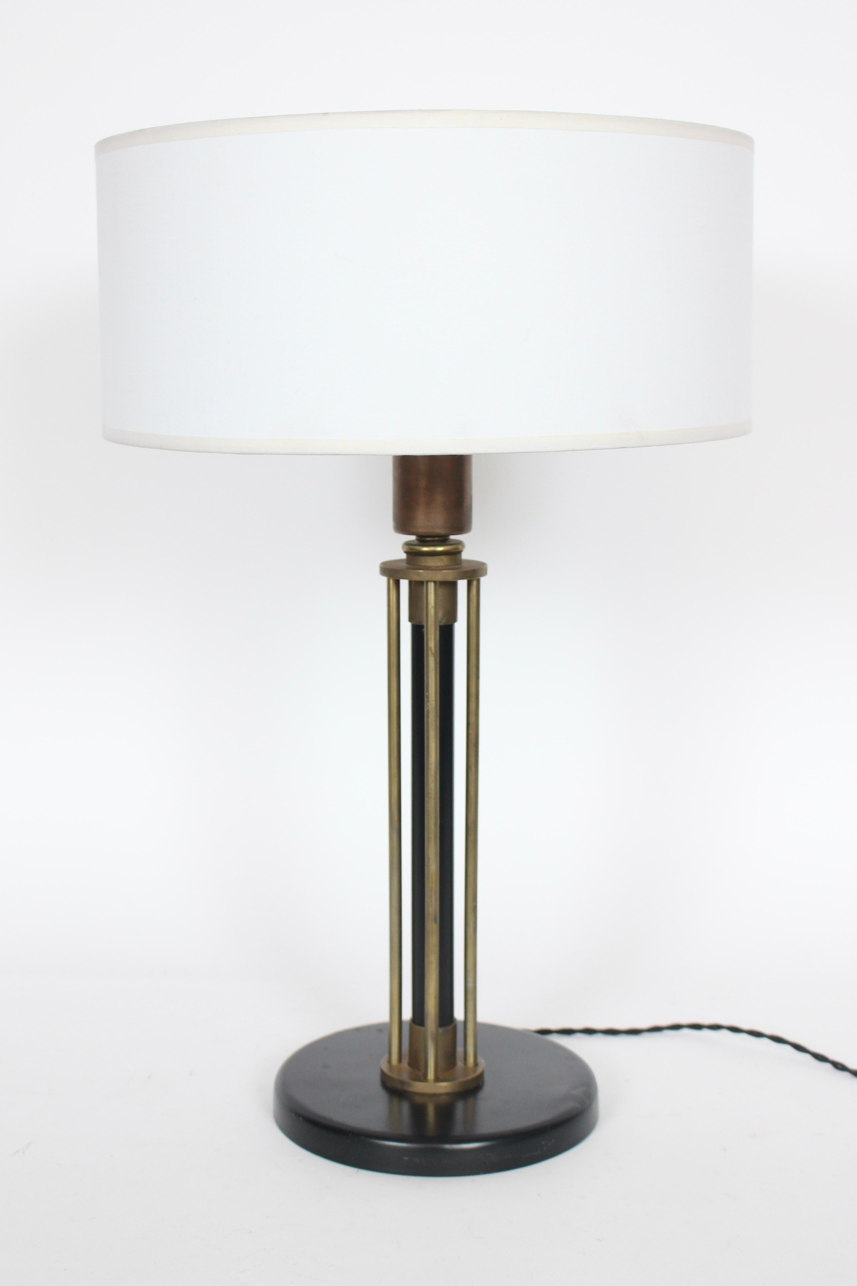 American Modernist Walter Von Nessen attributed brass column table lamp. Featuring an open five column architectural framework, with tubular Black enameled Brass center and four surrounding round Brass columns. With color variation to Brass neck. A