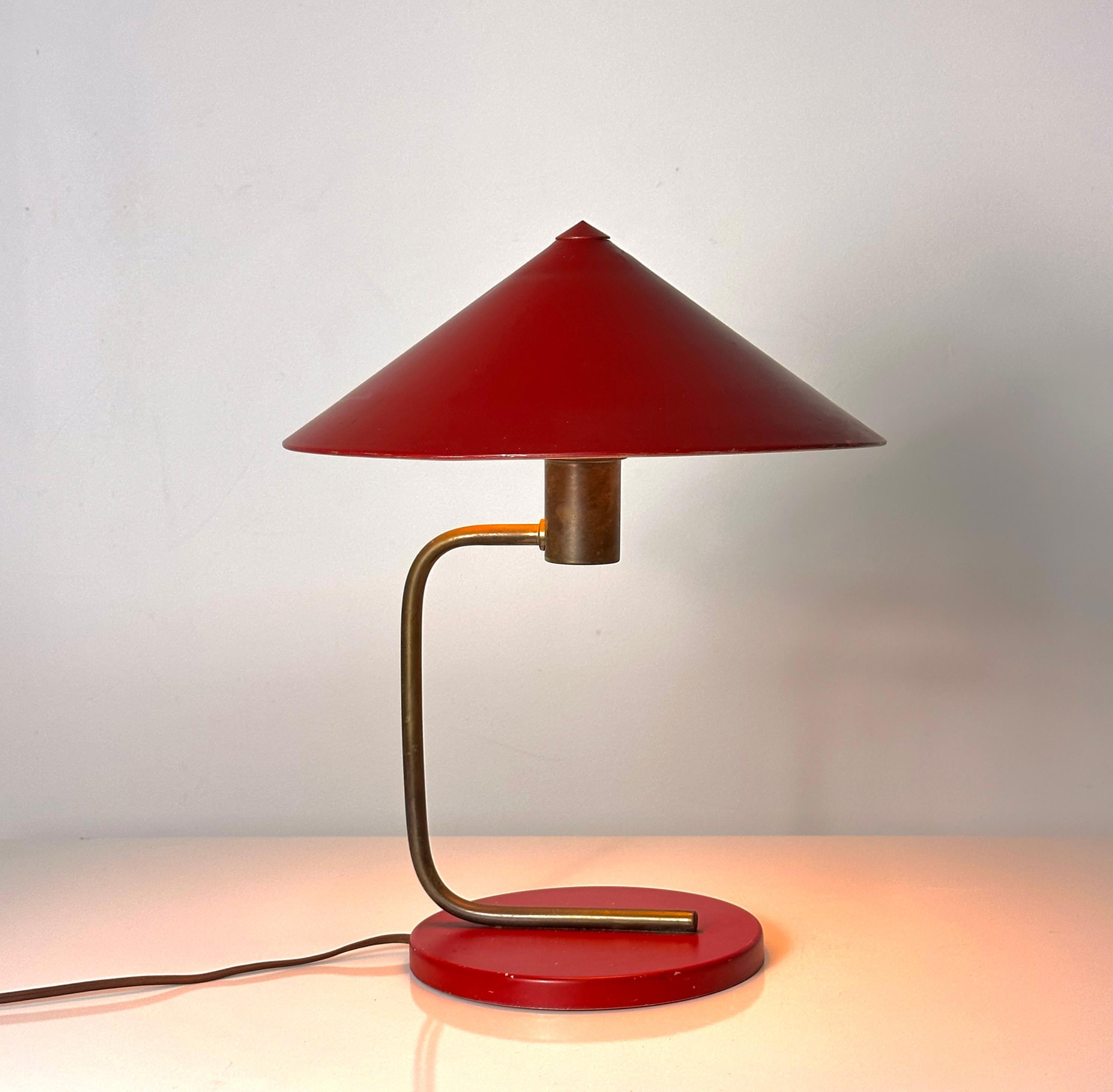 Iconic table lamp designed by Walter Von Nessen circa 1930
Red enameled aluminum canopy shade with brass arm on a red base
Stamped Spear CL2 to base