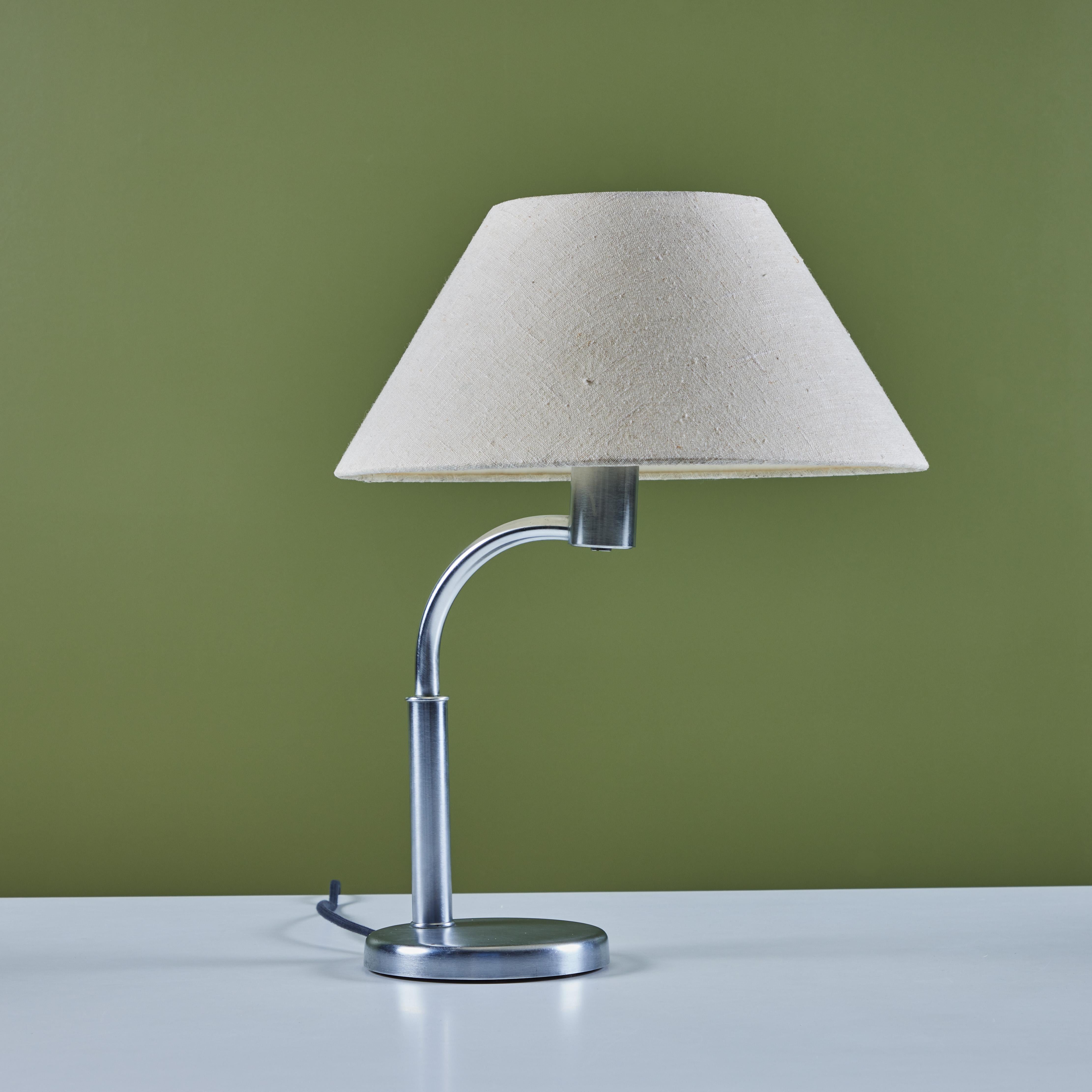 Walter von Nessen aluminum table lamp for Nessen Studio, c.1960s, USA. The table lamp features a curved aluminum stem and stainless steel base with original linen shade.

Dimensions
14