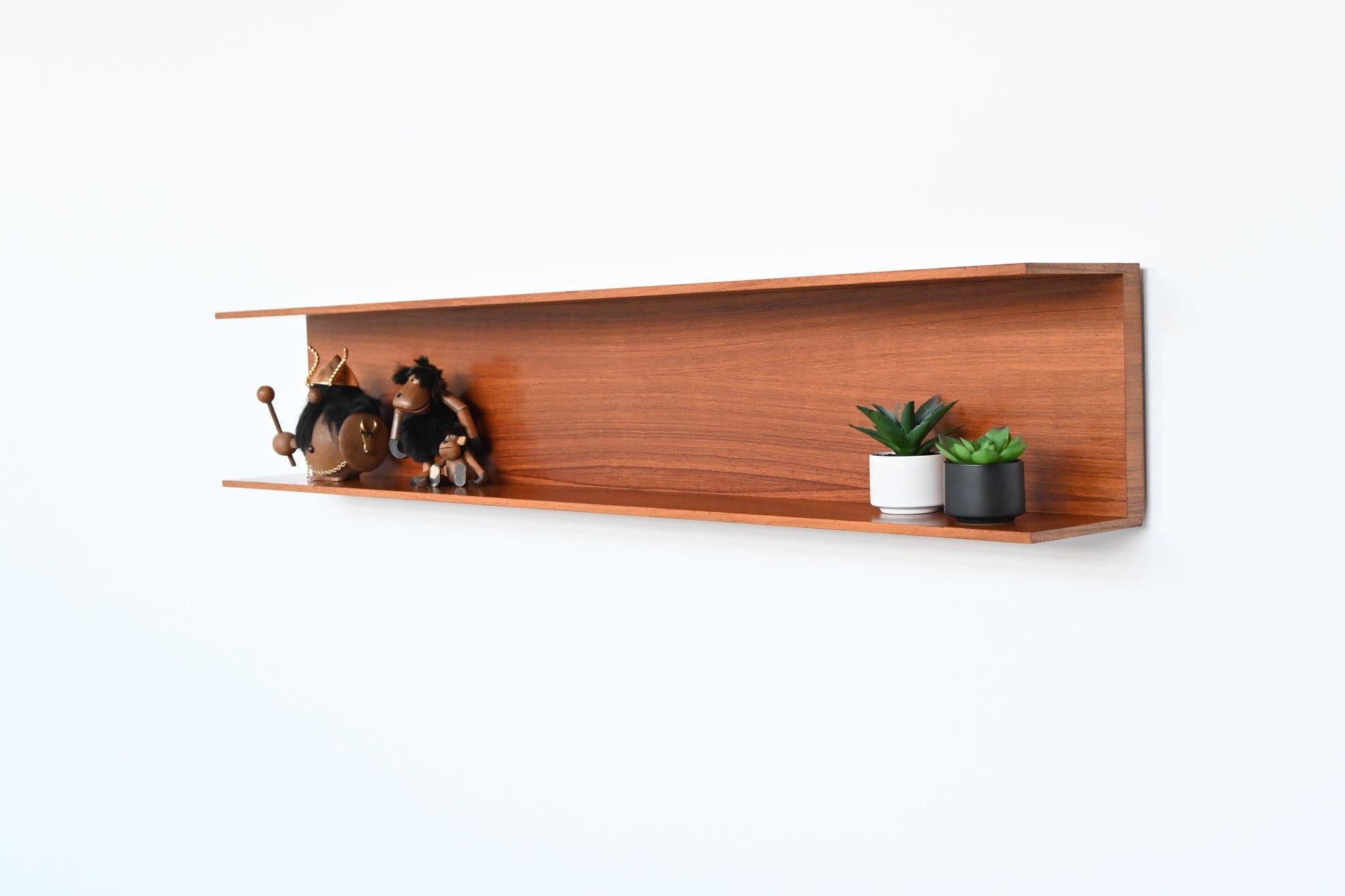 Beautiful minimalistic large wall shelf designed by Walter Wirz for Wilhelm Renz, Germany 1960. This U-shaped shelf is made of high-quality very nicely grained teak wood and can be mounted freely floating on the wall. Due to its simple design, it