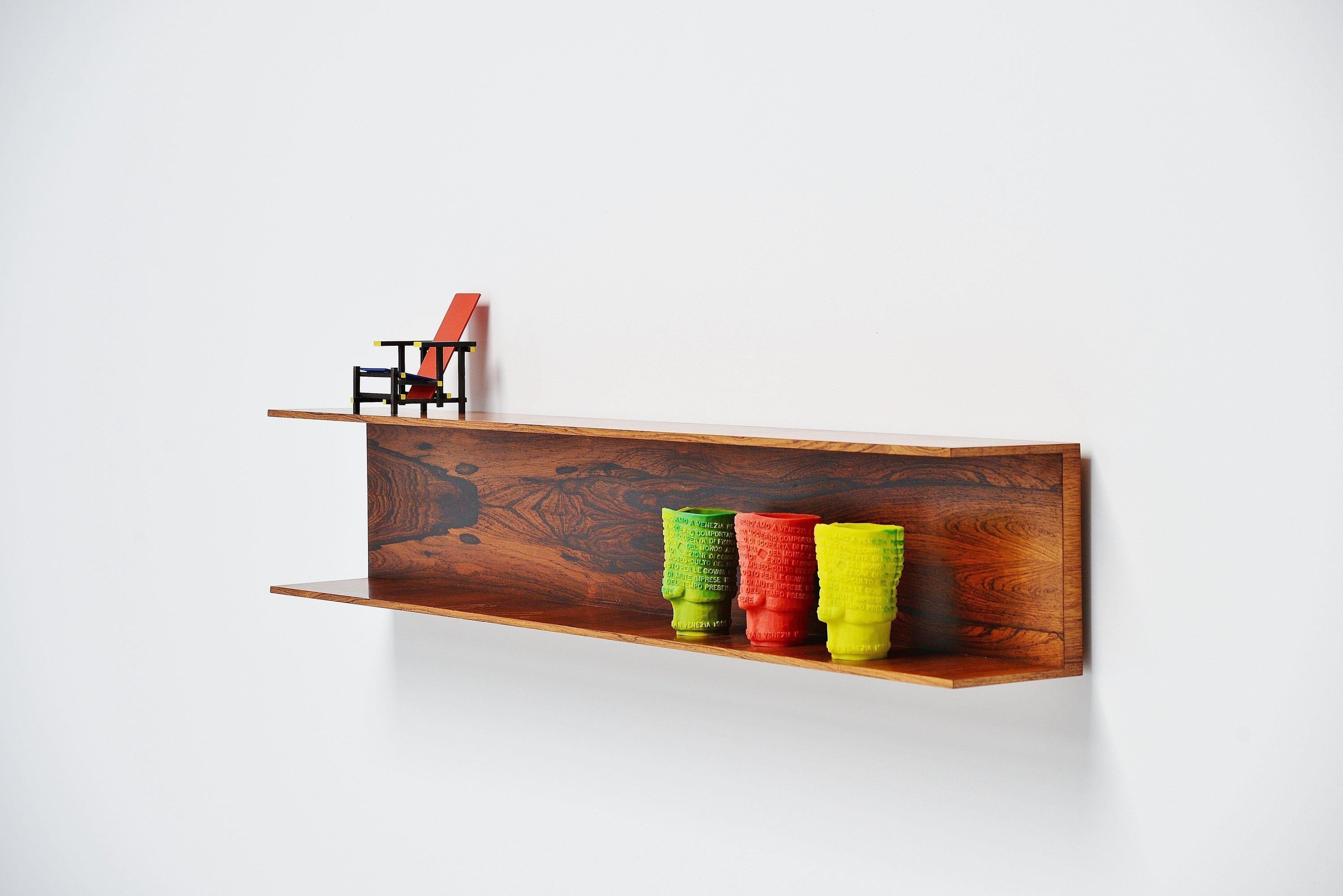 Minimalist wall shelve designed by Walter Wirz and manufactured by Wilhelm Renz, Germany, 1965. This super minimal wall shelve is made of rosewood veneer and has a fantastic warm and deep grain to the wood. Easy to wall hang using only 2 screws. The