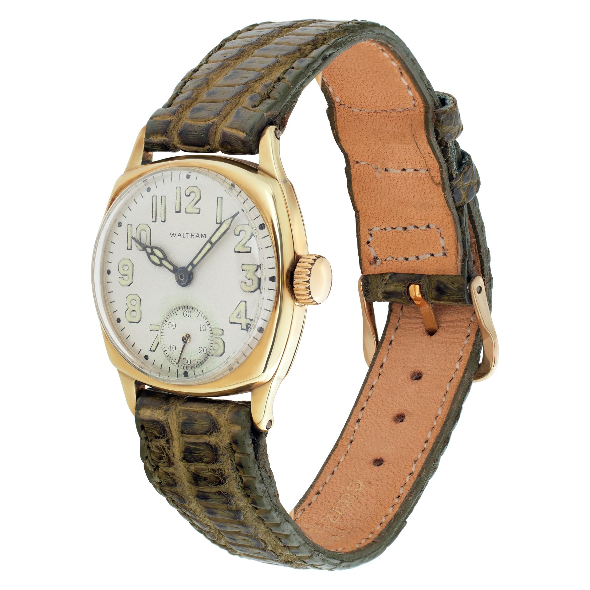 Vintage Waltham in 14k with cushion shaped case with a white dial with set luminous Arabic hour markers on a leather strap with a gold fill tang clasp. Manual w/ sub-seconds. Circa 1935.  Made in USA Fine Pre-owned Waltham Watch. Certified preowned