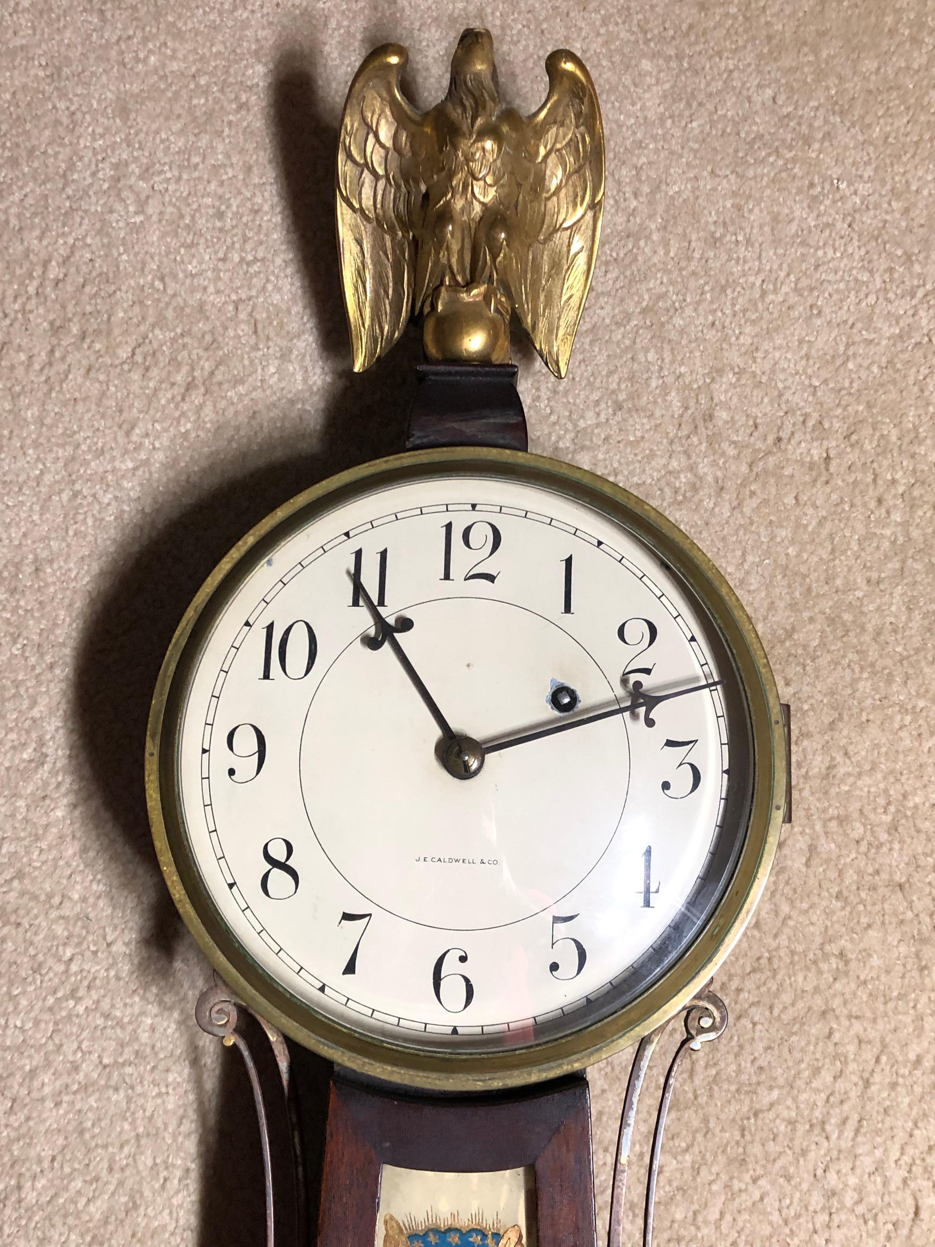 This is a very colorful Federal Massachusetts Improved Timepiece or “Banjo clock” made by the Waltham Clock Company of Waltham, Massachusetts.
This is a fine example. The brass movement is mounted to the clock with screws that attach the back plate