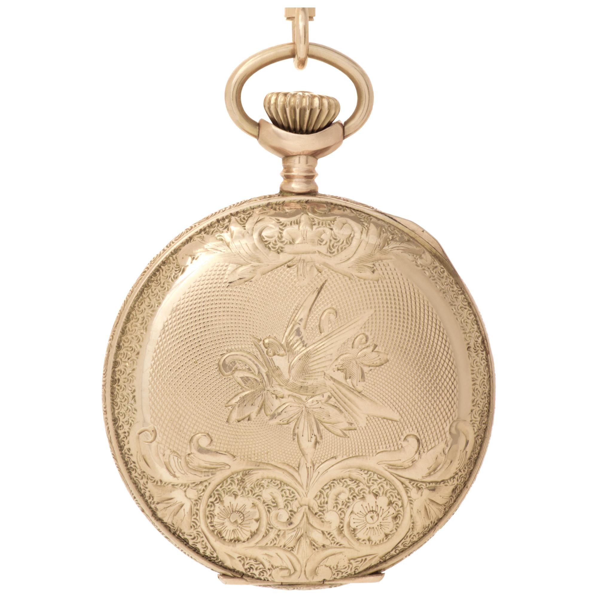 Waltham hunter case pocket watch in 10k yellow gold. 33 mm case size. Engraved floral design and the initial 