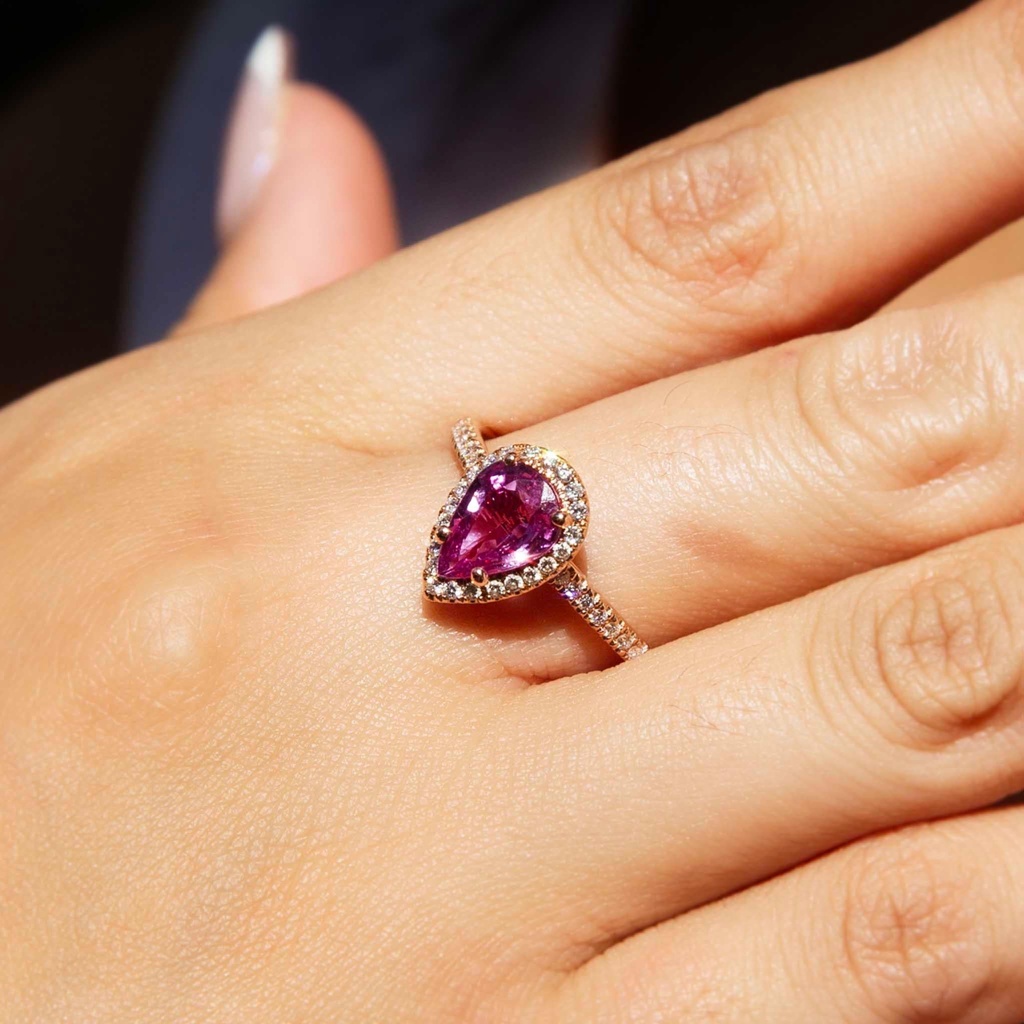 Intense love and compassion ignite in a gorgeous pear cut pink sapphire encompassed by a stunning border of brilliant diamonds. Finished with a plethora of diamonds down her perfect shoulders, The Wanda Ring will truly take your breath away.

The