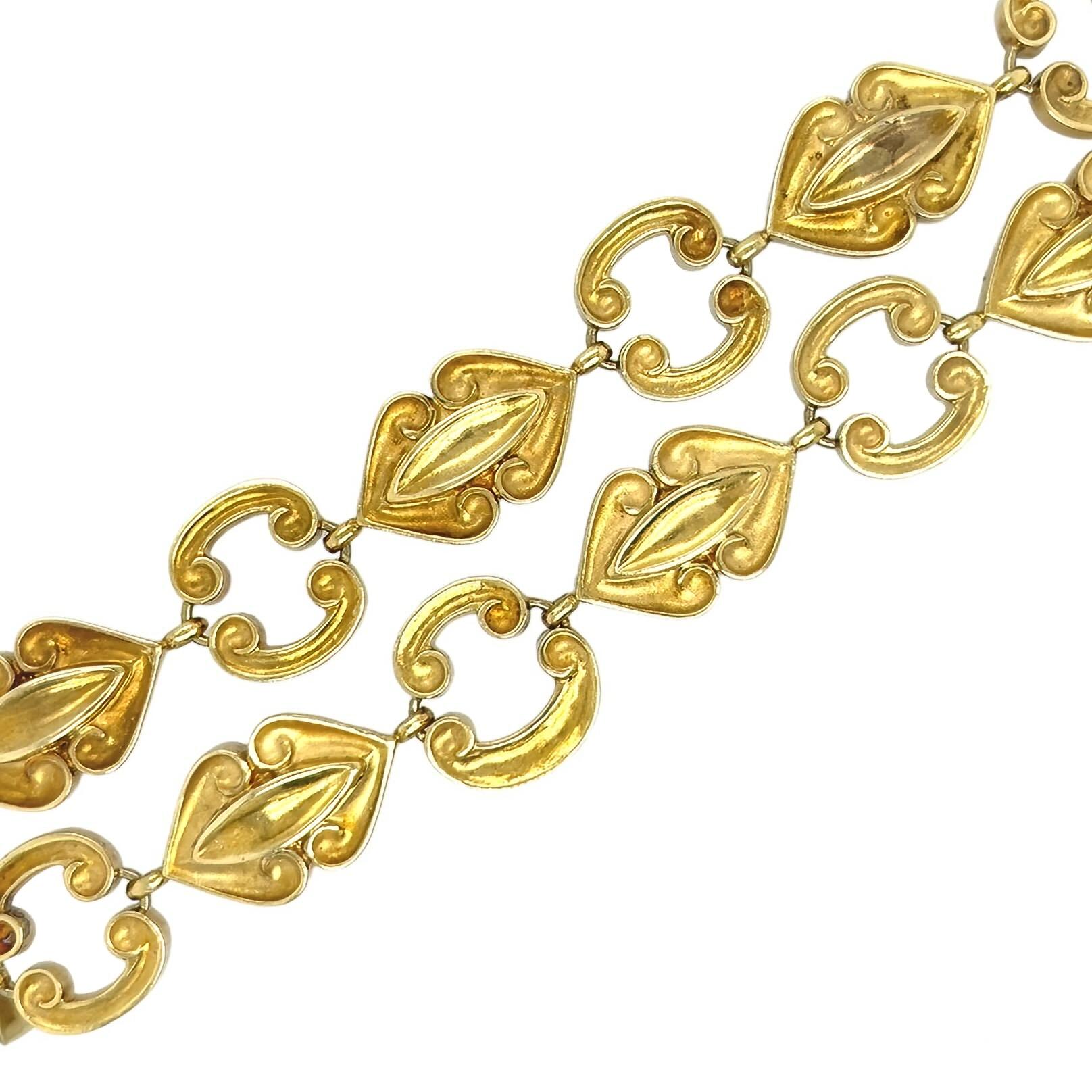 An 18 karat yellow gold necklace. Wander. French. Circa 1960. Designed as alternating polished and matte gold scrolling and navette shaped links, length is approximately 28 3/4 inches, divides into two necklaces measuring approximately 15 1/4 inches