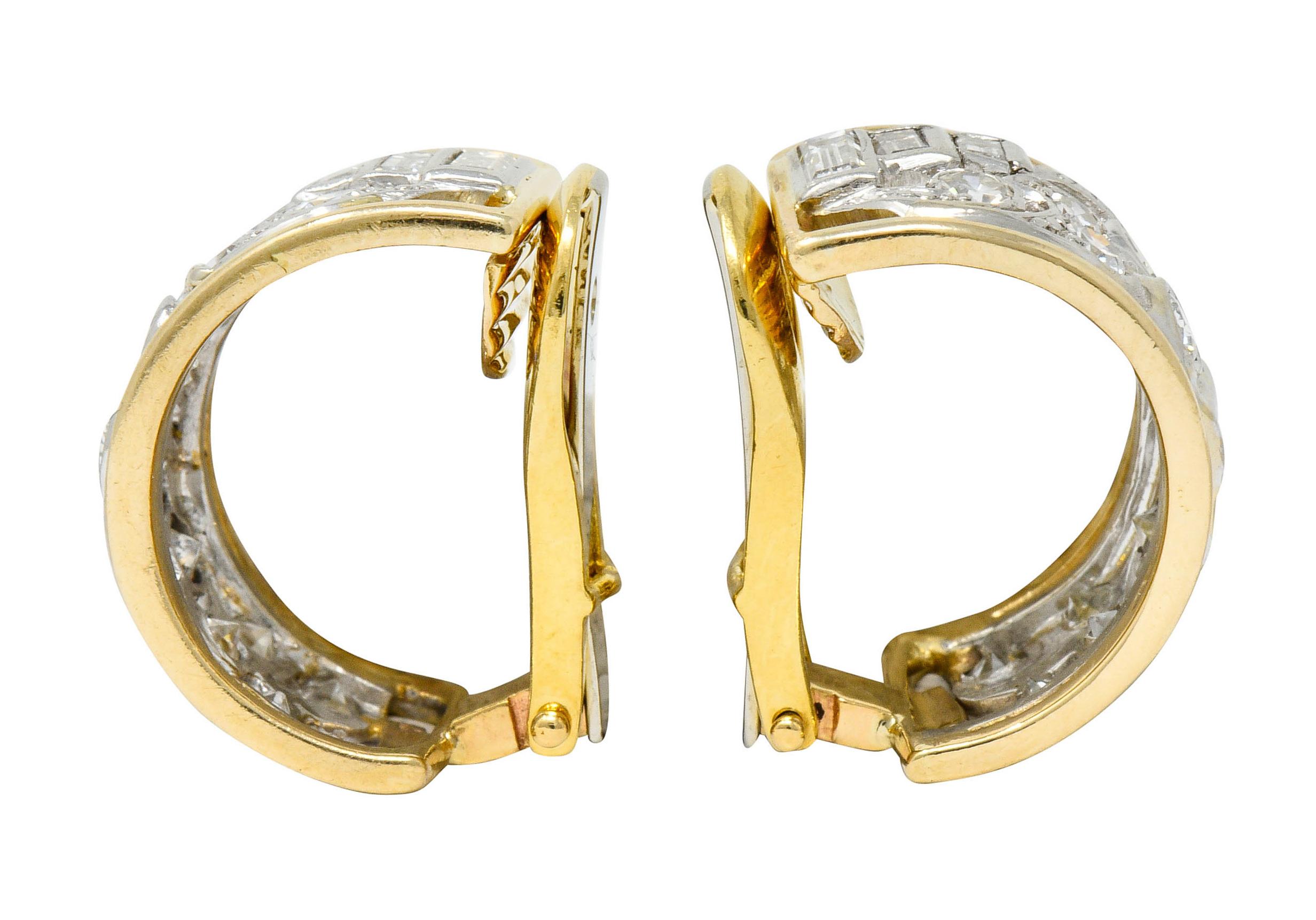 J hoop style earrings have a polished gold frame with a pierced platinum center

With a scrolling design accented with single and baguette cut diamonds

Weighing in total approximately 2.00 carats with G to I color with SI clarity

Tested as 18