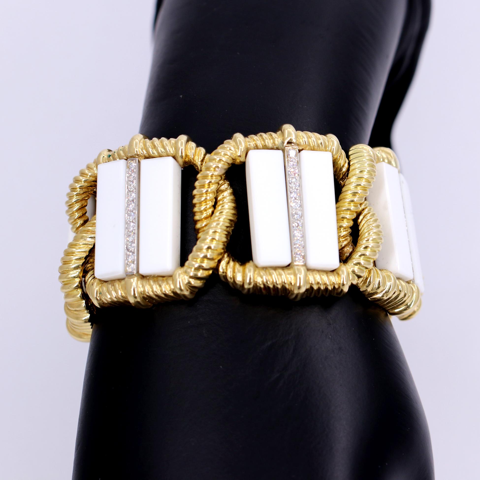 An 18 karat yellow gold bracelet measuring 1 7/16 inches wide, comprised of 6 interlocking twisted rope links, each set with two slabs of white onyx. Each link also features a strip of 11 round brilliant cut diamonds set in platinum. Diamonds weigh