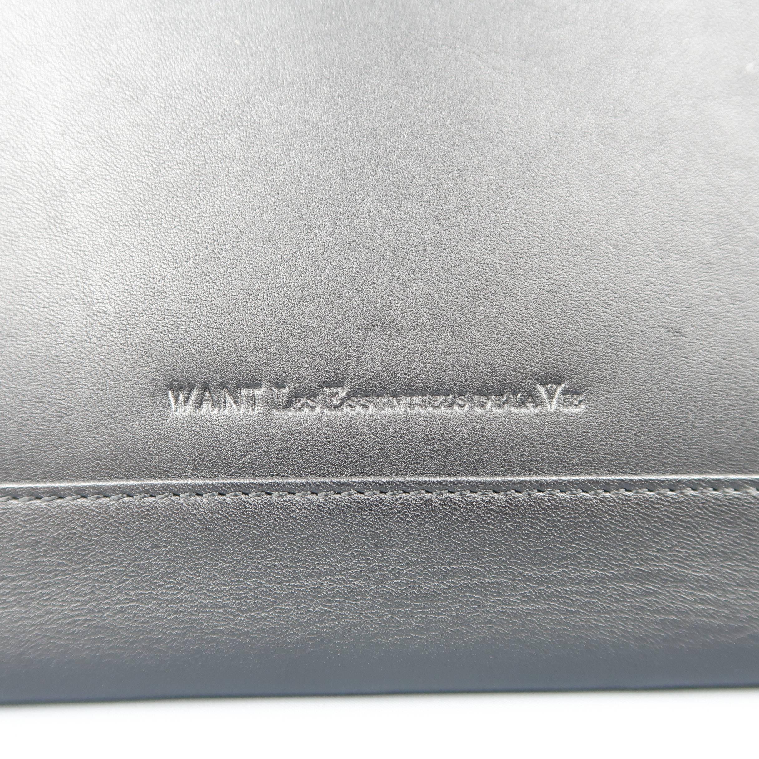 WANT by LES ESSENTIELS DE LA VIE ipad tablet case comes in black leather with a gold tone zip closure and rust interior. Wear throughout.
 
Fair Pre-Owned Condition.
 
Measurements:
 
Length: 10 in.
Width: 0.5 in.
Height: 8.5 in.
