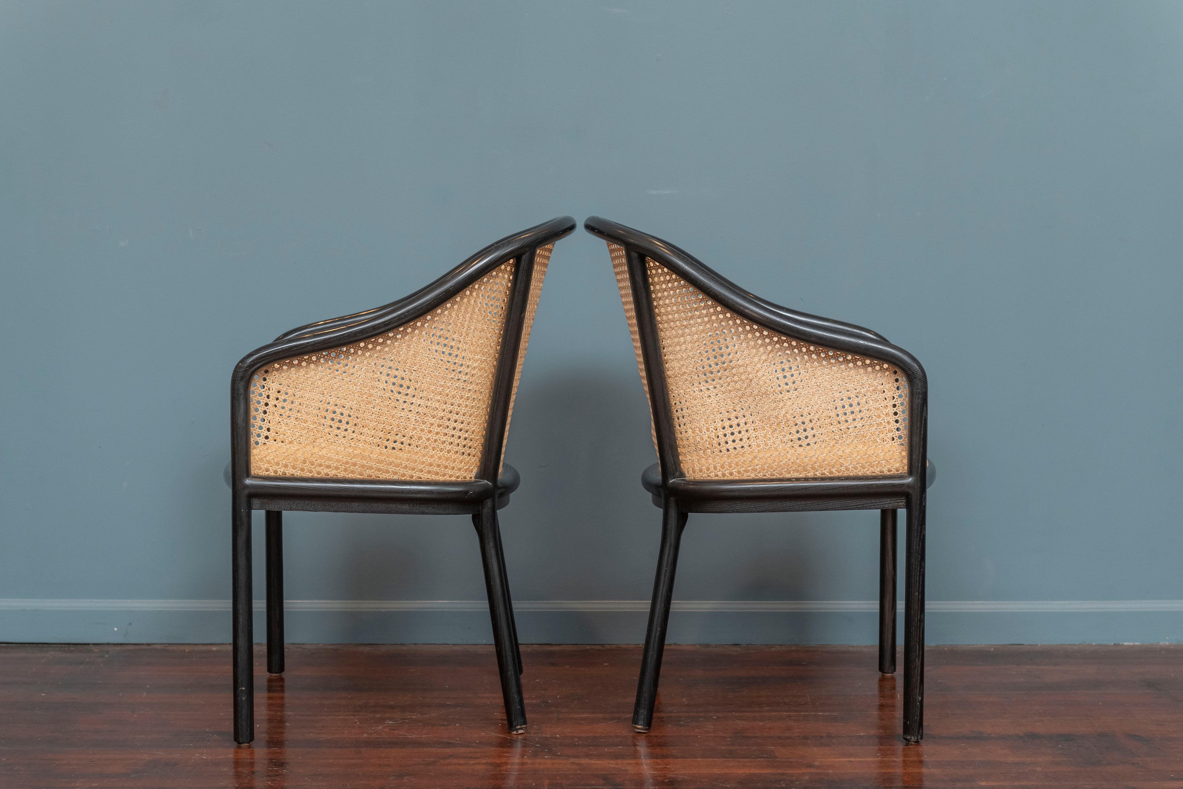 Ward Bennett design armchairs for Geiger Brickel Assoc. Timeless classic style and comfort, newer production examples ebonized and caned frames with upholstered slip cushions. 
In very good condition with one strand of cane broken on interior side