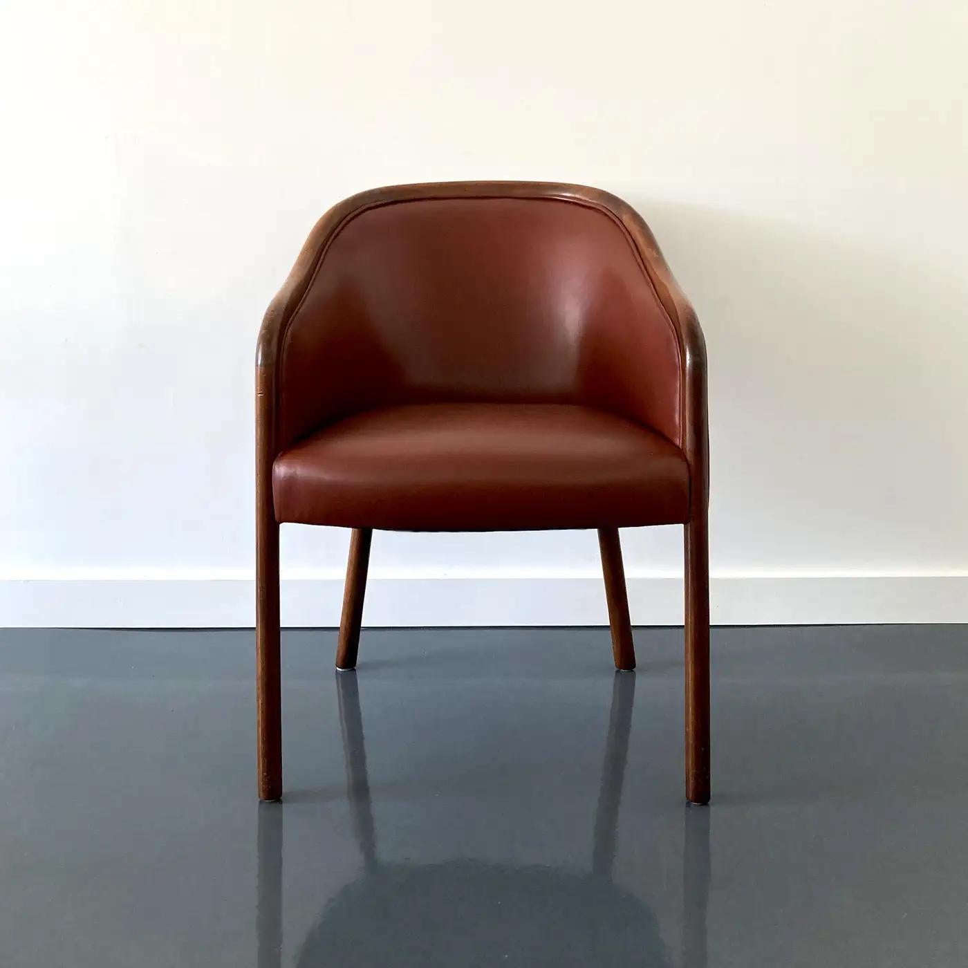 Designed by Ward Bennett for Brickel Associates, elegant leather armchair. Made from ash wood and stained in a walnut finish, upholstered in burgundy leather. The chair is structurally sound and sturdy, some wear and scuffs to bentwood arms. Sold as