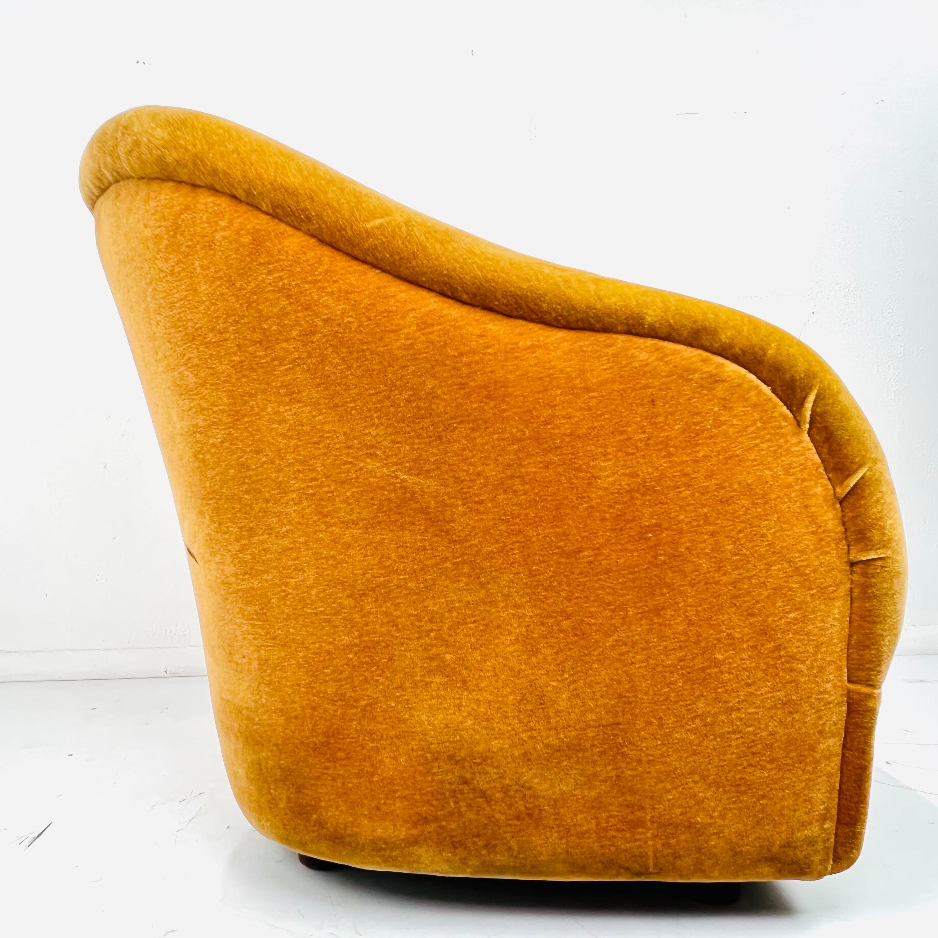 Bring a distinctive look to your seating area with this sleek club chair model no.Q2083 by Ward Bennett for Brickel Associates, 1960s. Featuring a tub form with tapered sides and plush rounded back with a central channel, the gold mohair chair rests