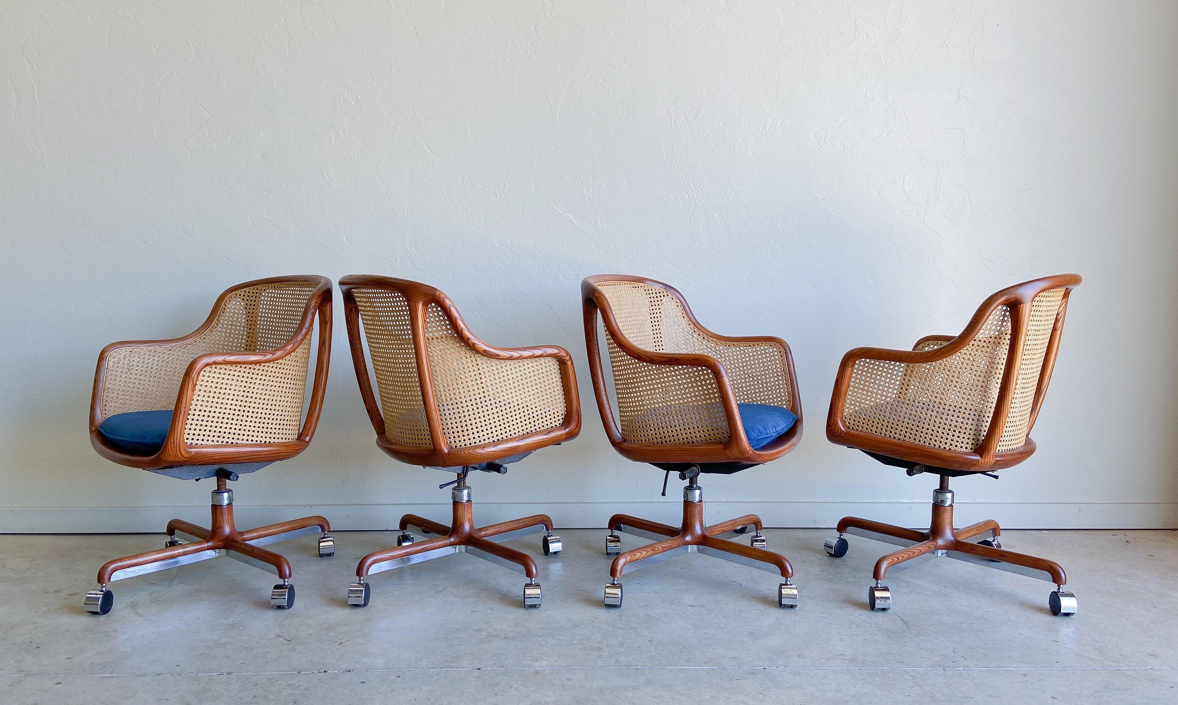 Offered is a beautiful and rare fully caned desk chair designed by Ward Bennett, and produced by Brickel Associates. We have a total of three available. Please note the upholstery is a more subtle blue than shown in the pictures. We've attached a