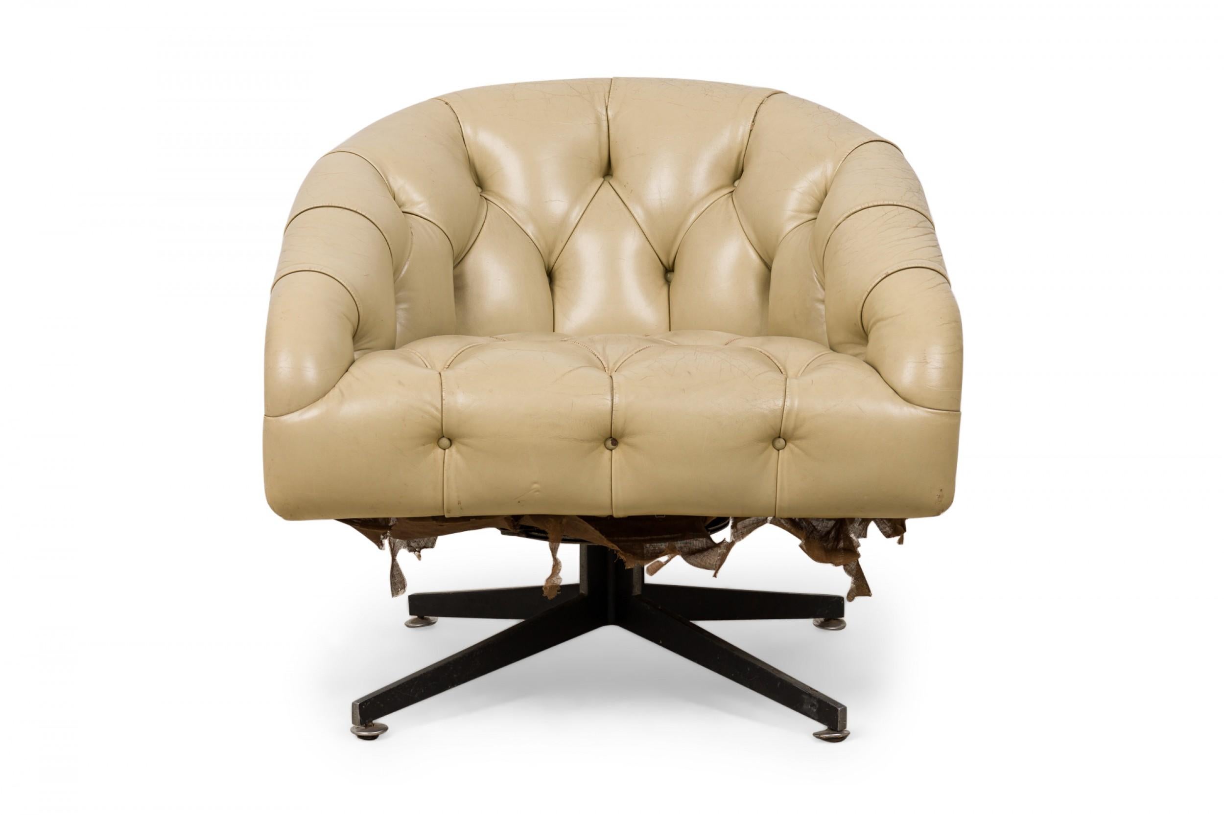 American mid-century tub-form swiveling lounge / armchair with beige button tufted leather upholstery, resting on a four leg brushed chrome pedestal base. (WARD BENNETT)