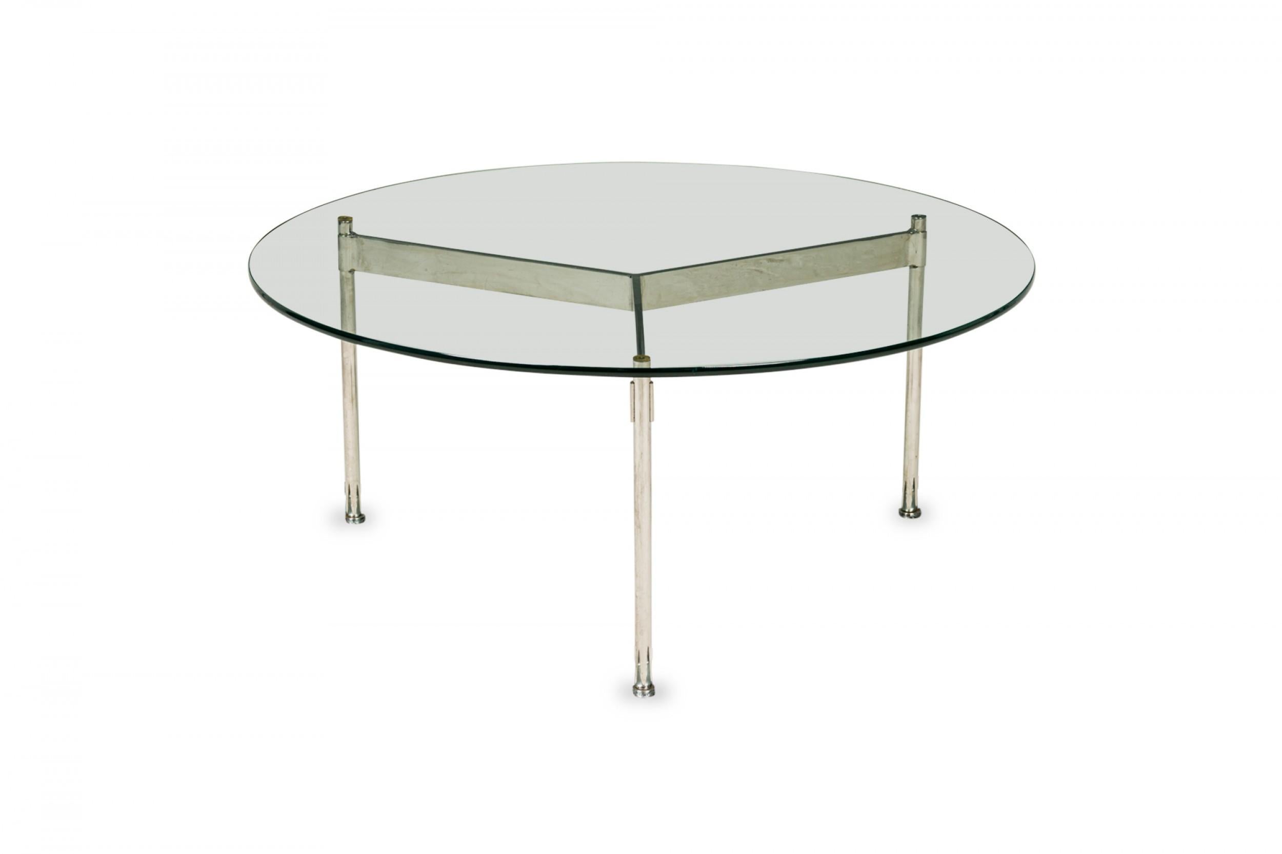 American Mid-Century round coffee / cocktail table with a circular clear glass top resting on a three bar chrome plated steel base. (WARD BENNETT)
