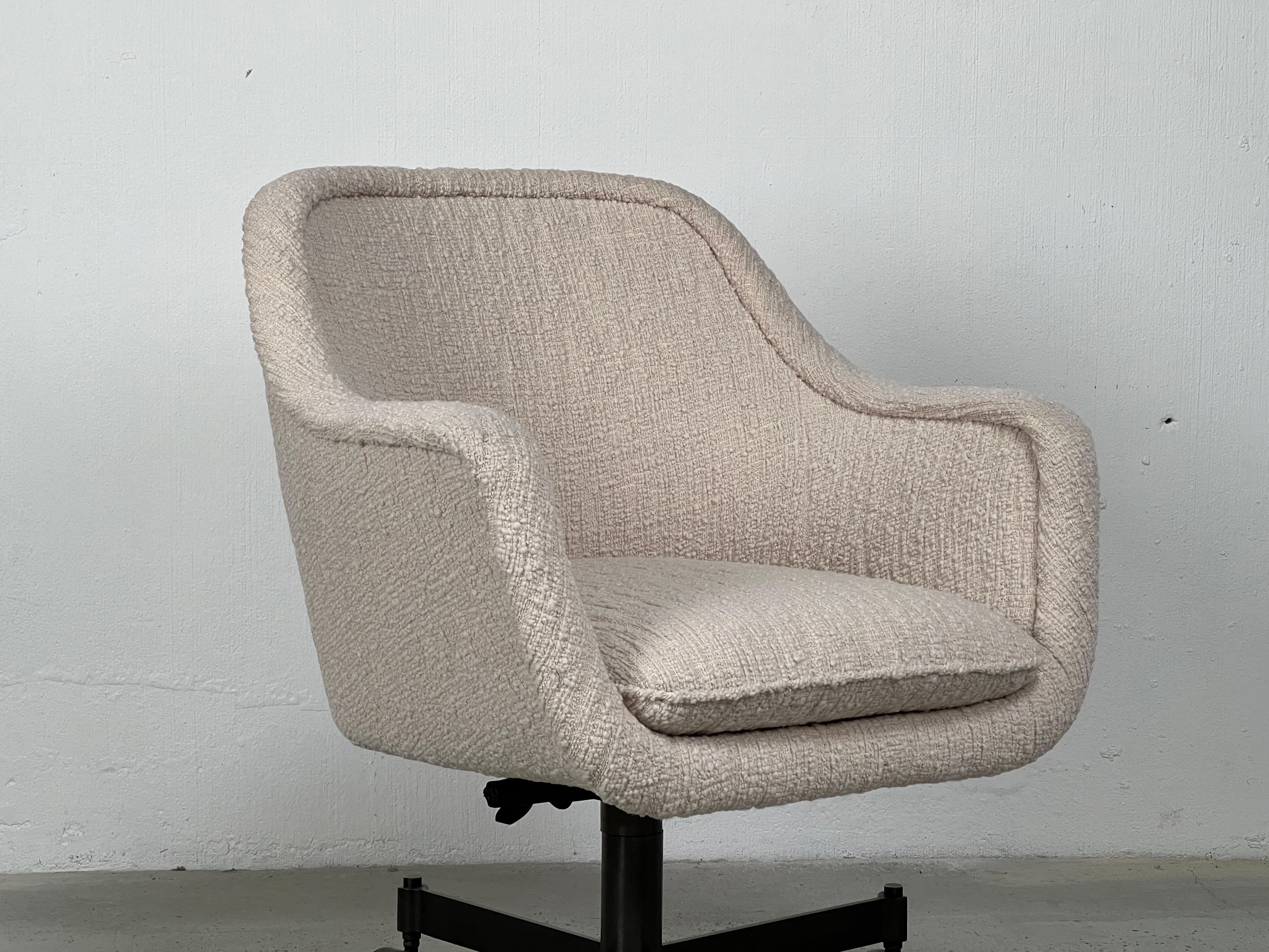 A tilting desk chair with bronze base designed by Ward Bennett. Height adjustable. Reupholstered in a Holly Hunt fabric.