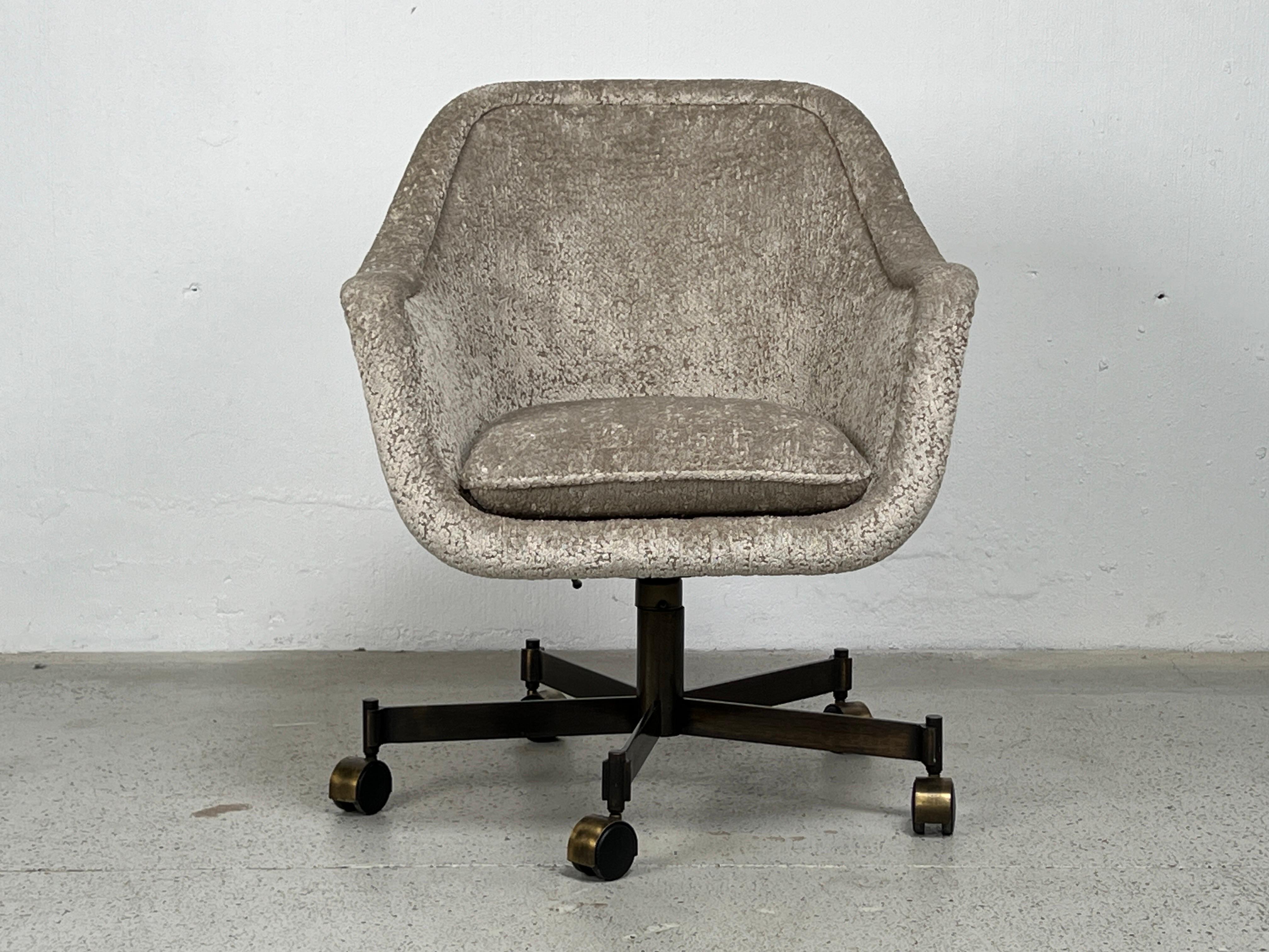 A tilting desk chair with bronze base designed by Ward Bennett. Height adjustable. Reupholstered in a Holly Hunt fabric.