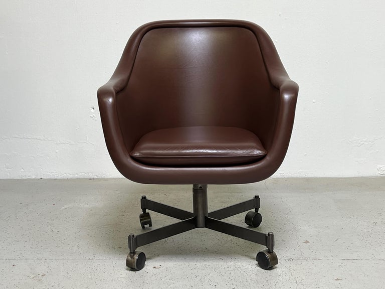 A desk chair designed by Ward Bennett for Brickel. Original reddish-brown leather seat on bronze base. Tilting back and adjustable height. Several available. 