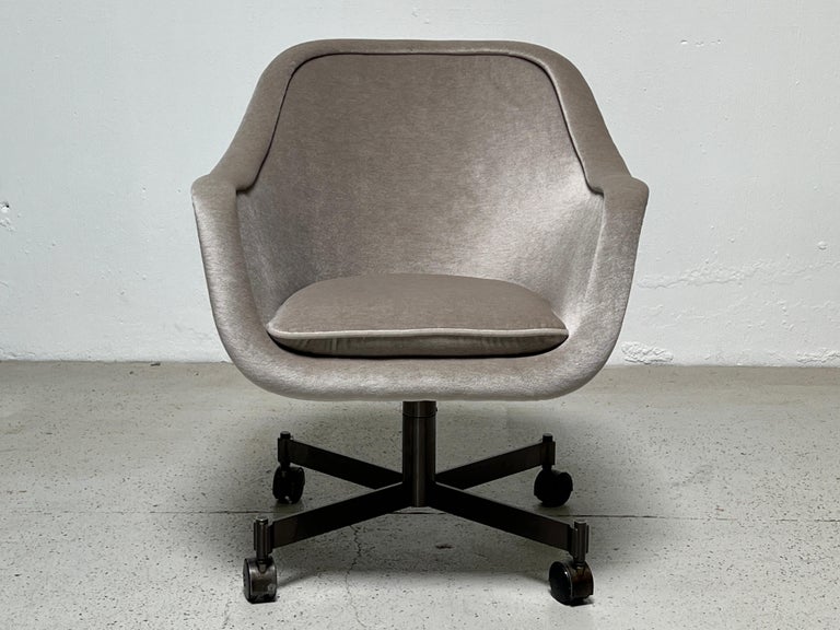 A Ward Bennett desk chair with bronze base. Reupholstered in silver mohair.