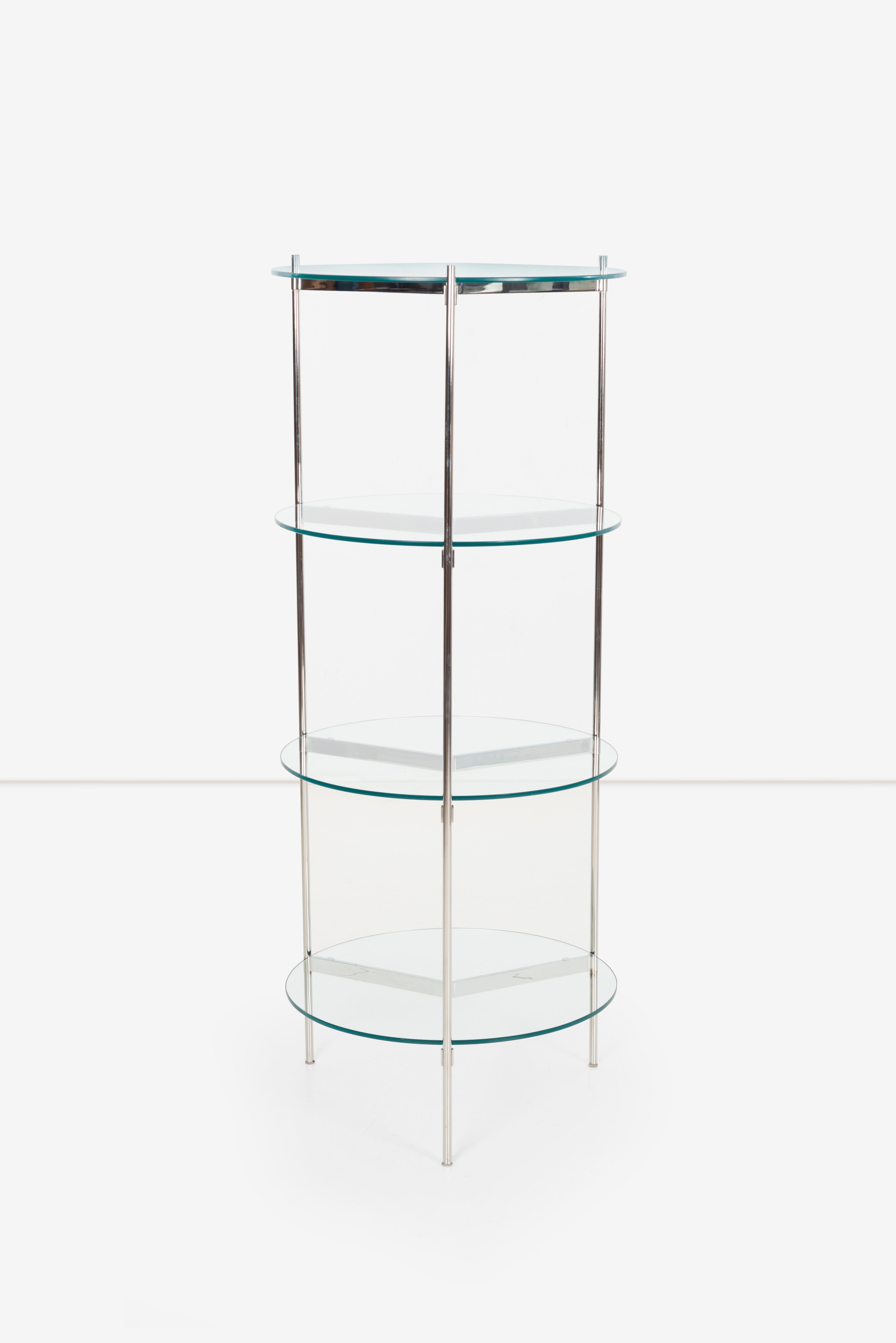 This etagere designed by Ward Bennett is a stunning piece of furniture that perfectly embodies the designer's minimalist aesthetic. This etagere features a cylindrical shape, which is both unique and visually striking. The chrome plated finish adds