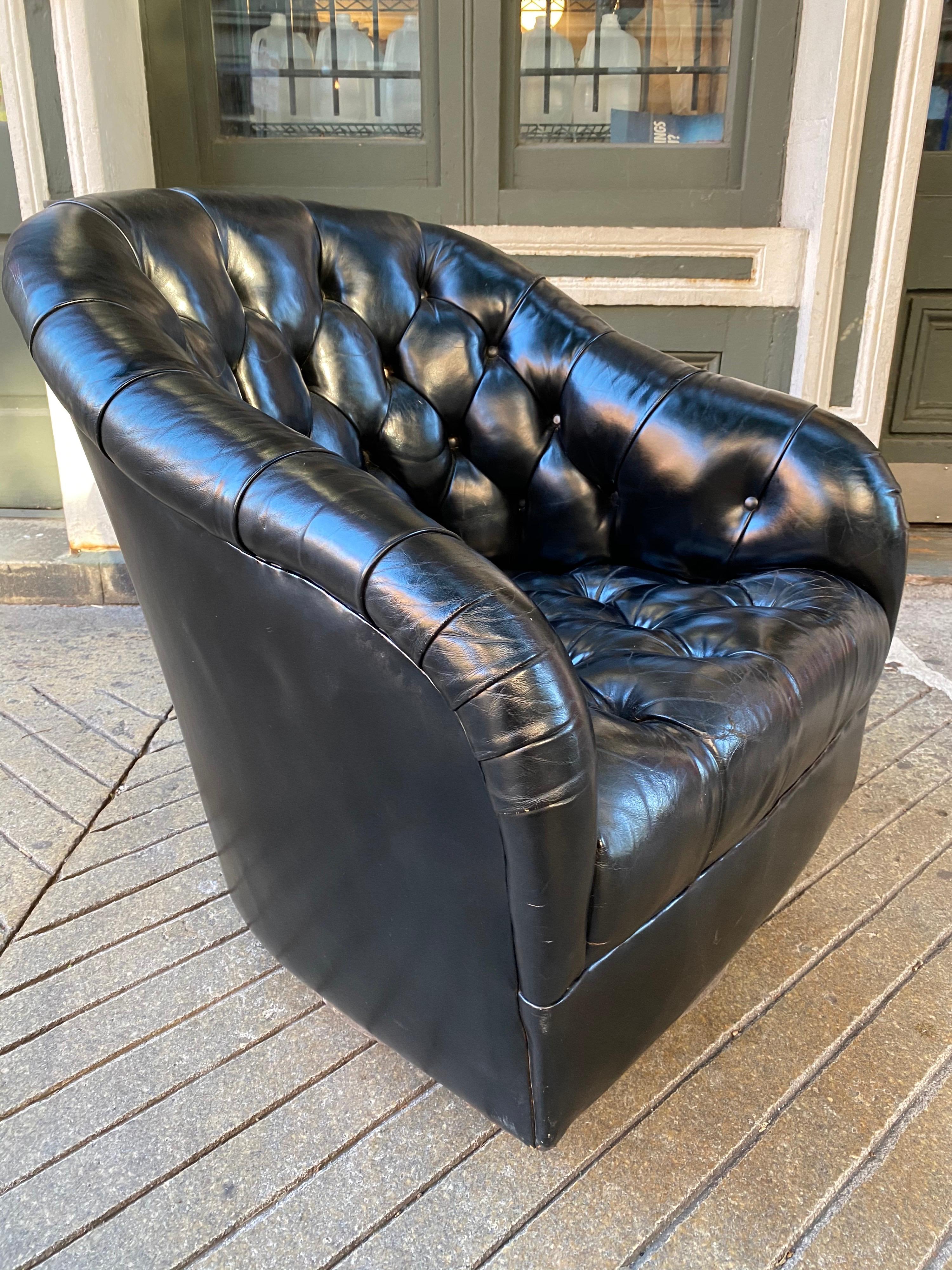 Ward Bennett for Brickel tufted black leather swivel chair. Beautiful black leather with just the right amount of patina! Very comfy, sink into this luxurious chair and swivel!