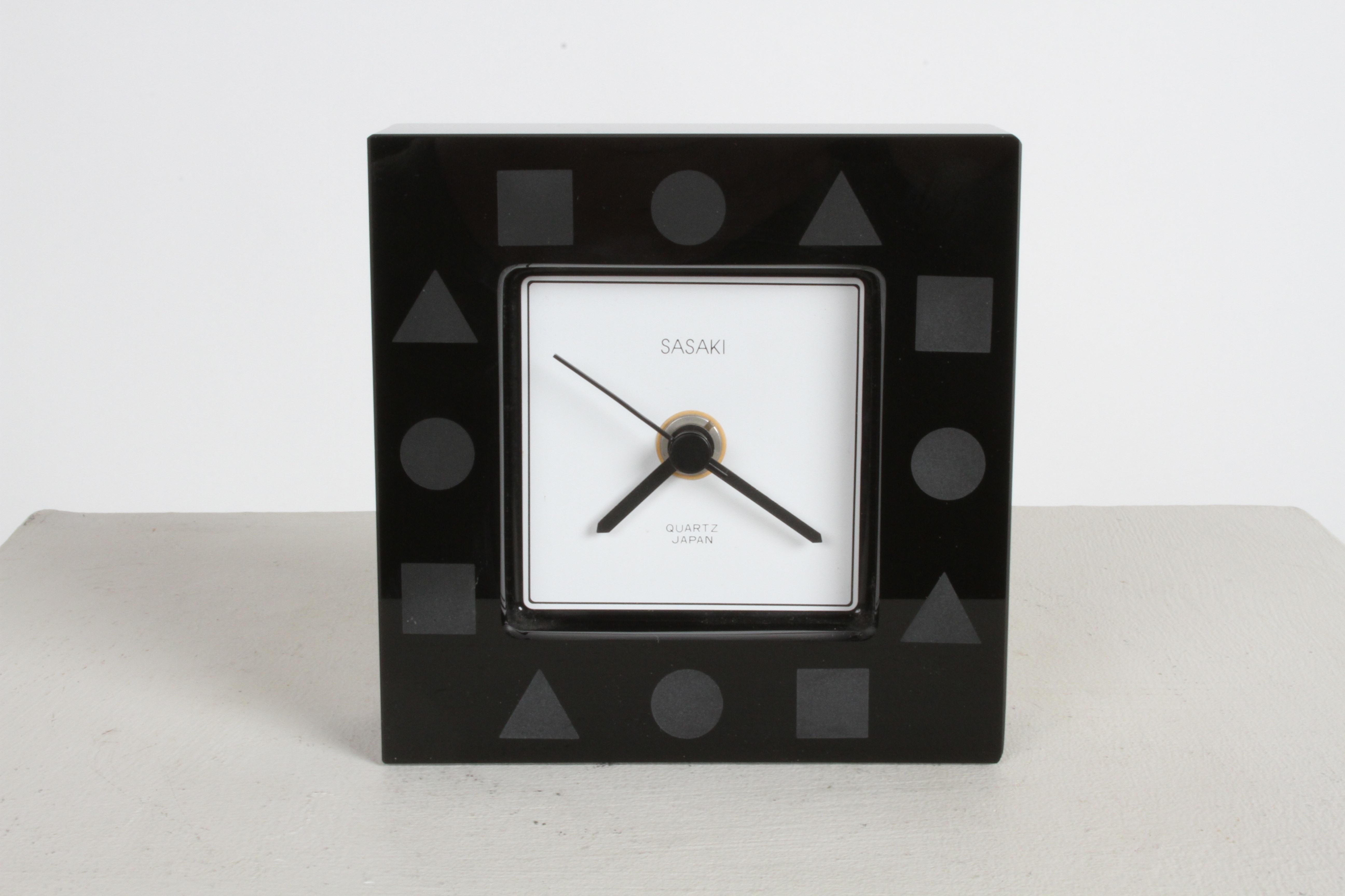 A Ward Bennett design for Sasaki Japan 24% black lead crystal, quartz movement desk or dresser post-modern clock. With etched circle-triangle-square. 