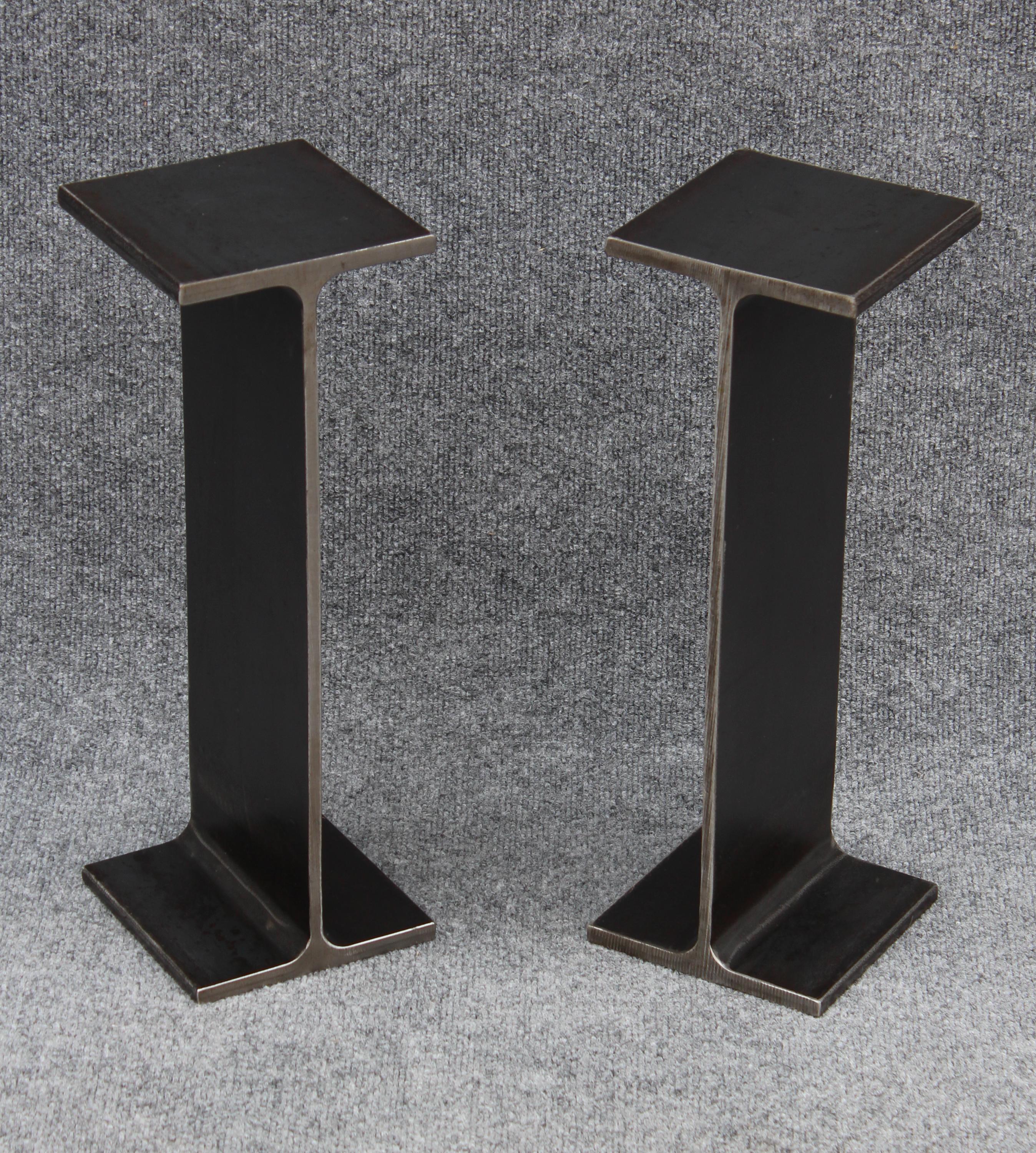 In creating a prototype, Ward Bennett actually cut off a section of a steel I-beam to achieve the raw aesthetic he was after. Here, a pair of solid enameled steel drink stands after his innovative design. Each is very well made, with crisp surfaces